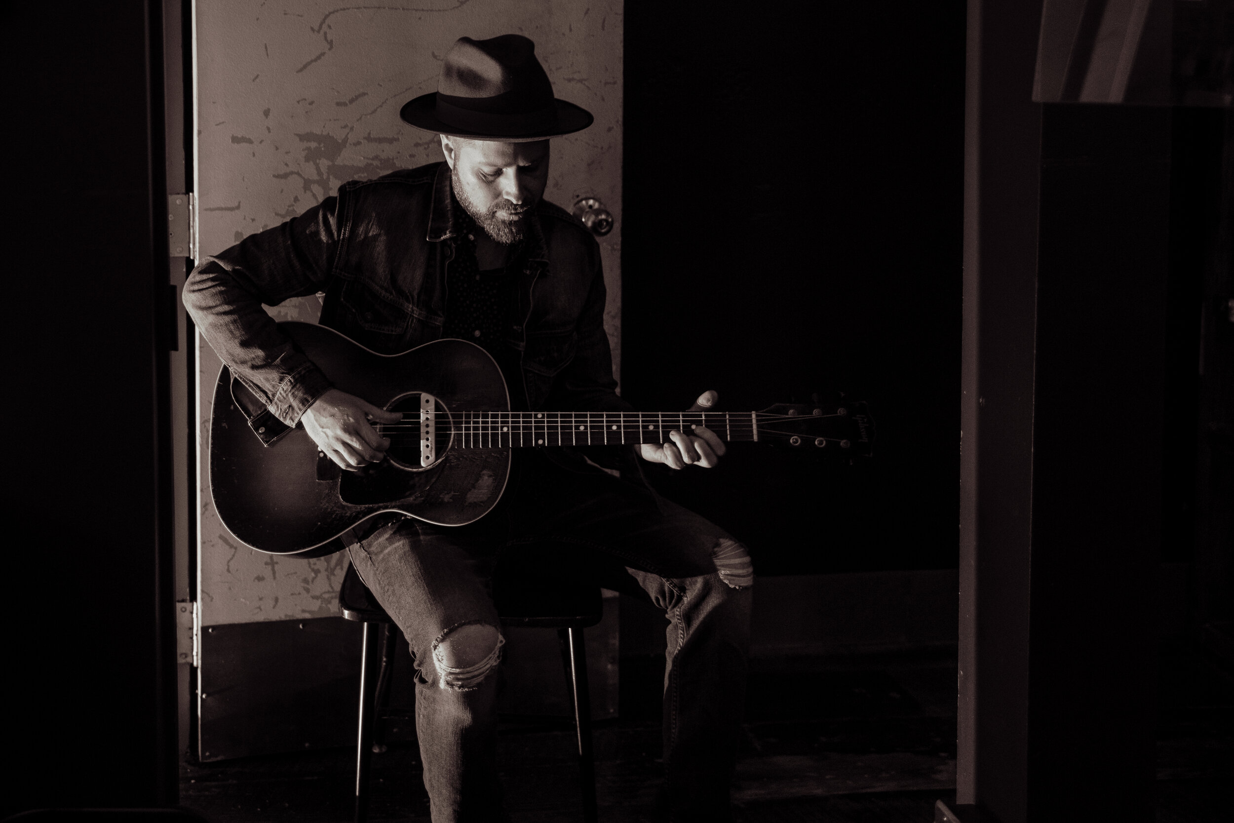 black and white image of a man playing guitar.jpg