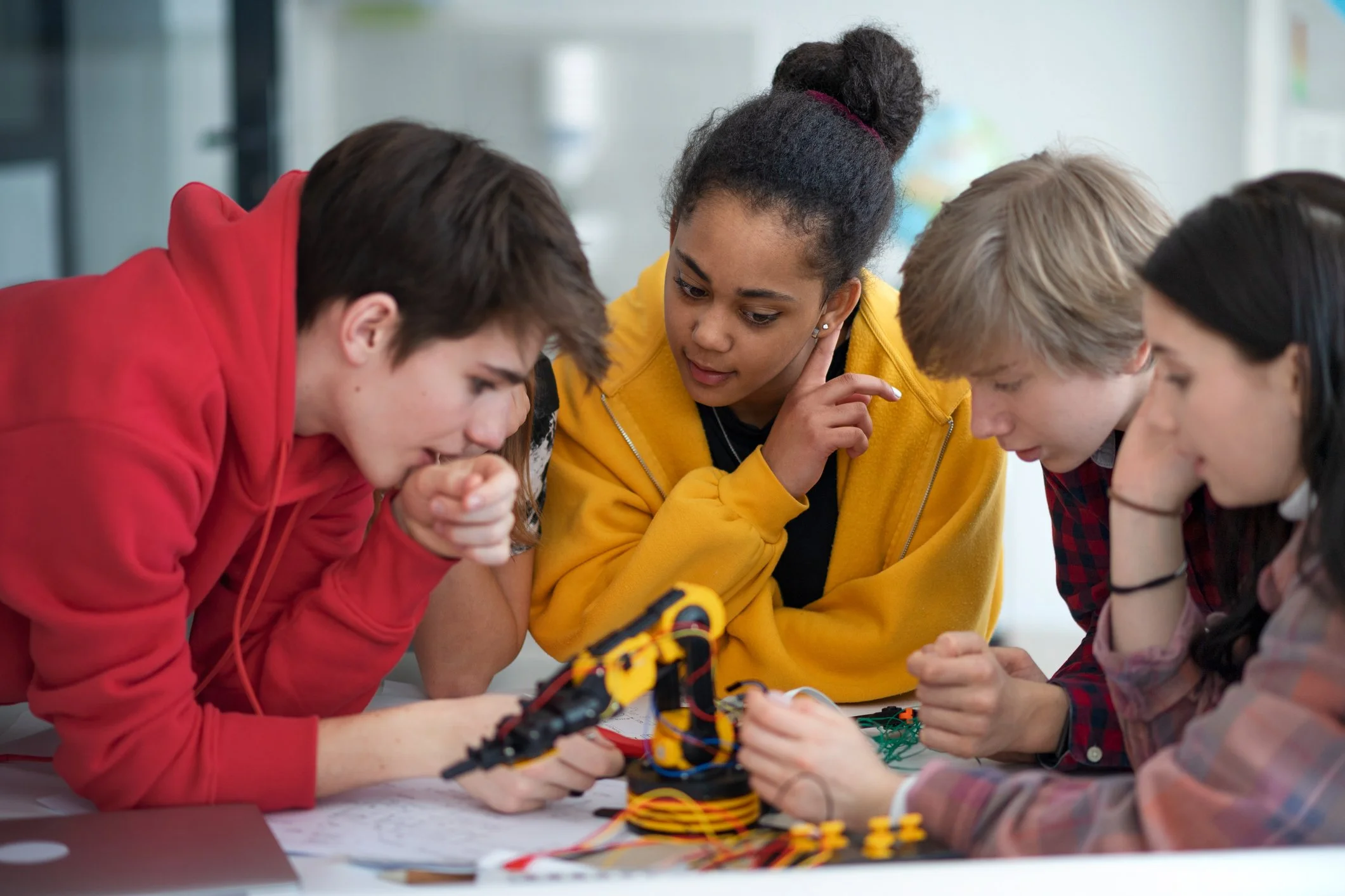 A group of teenagers gathers for robotics club.
