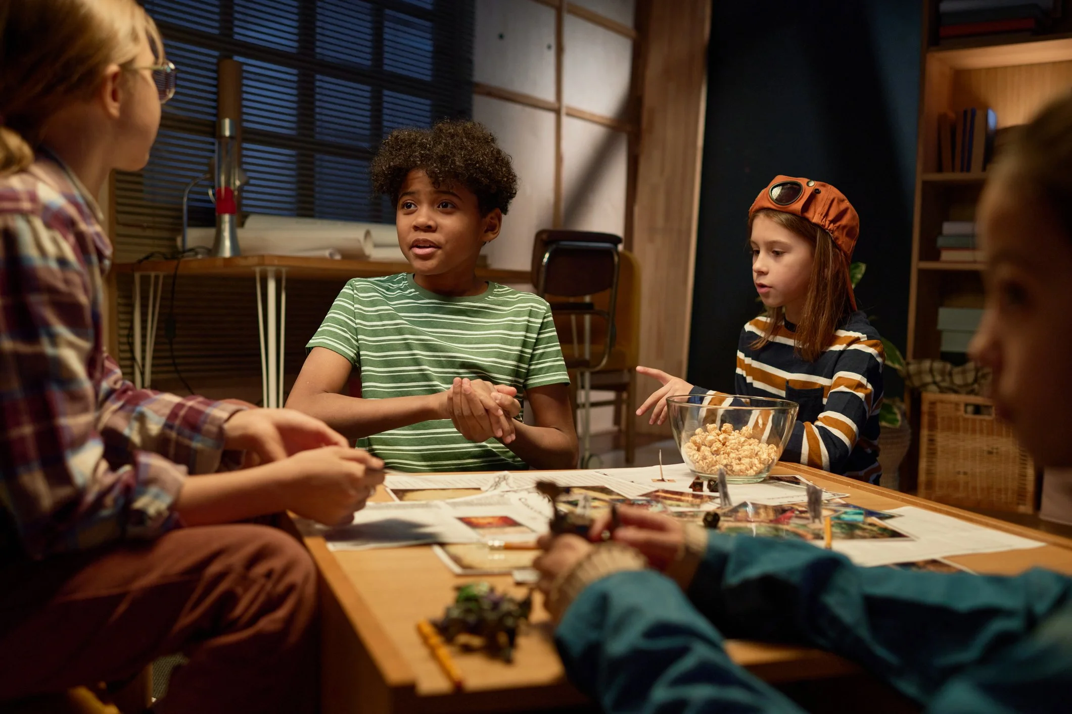 Four tween player gather to play Dungeons & Dragons.