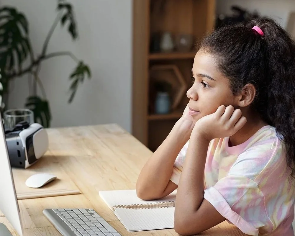 Tween participating in an online group from home.