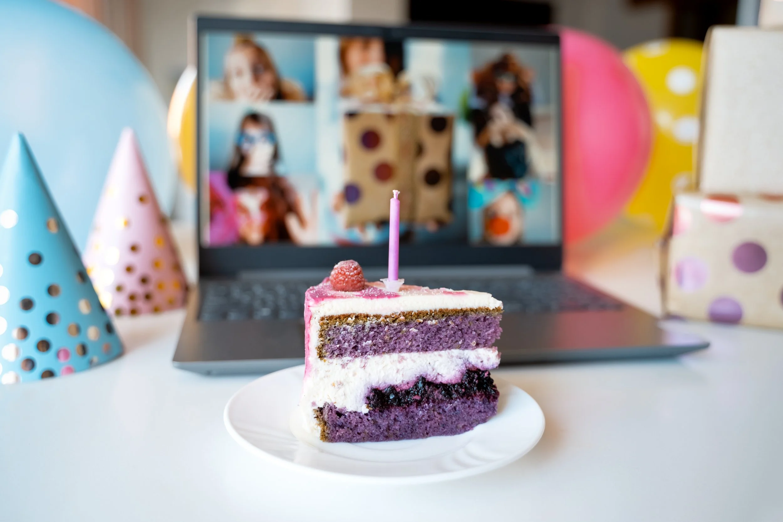 A group of kids join a Zoom call with birthday cake in the foreground.