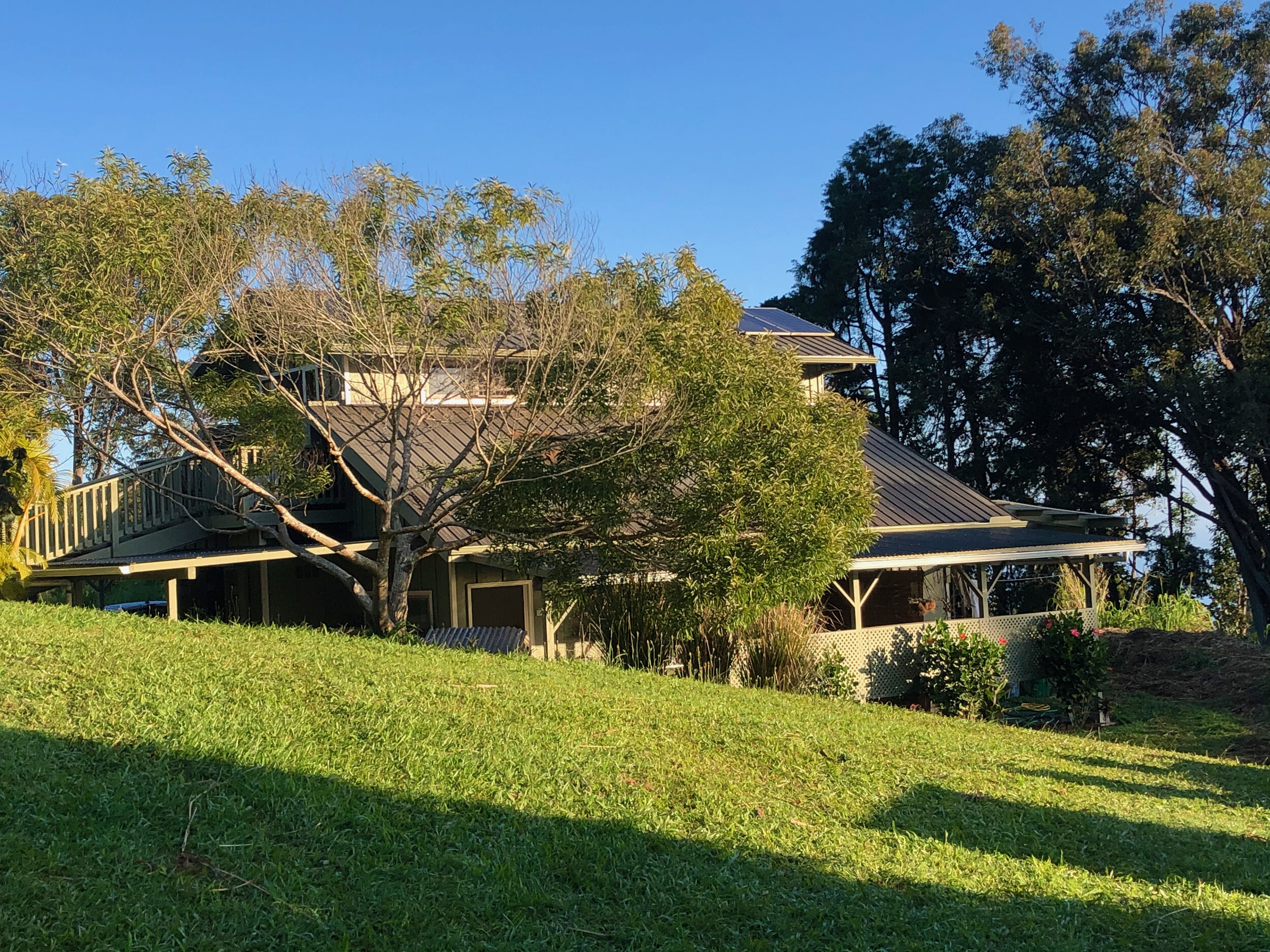 “As soon as possible we designed and built this beautiful barn with a spacious upstairs area to sleep in after a long day of hard work!  Downstairs there was plenty of room for a Kubota tractor, tools, and equipment.  We even made space for a small kitchen and bathroom.  Of course we immediately set up water catchment and solar which were essential since this property was and still is completely off-grid.”