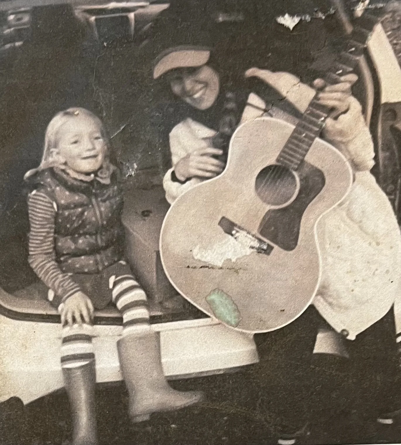 Lizzie West playing music for her daughter while traveling for Camp Now Kiosk's