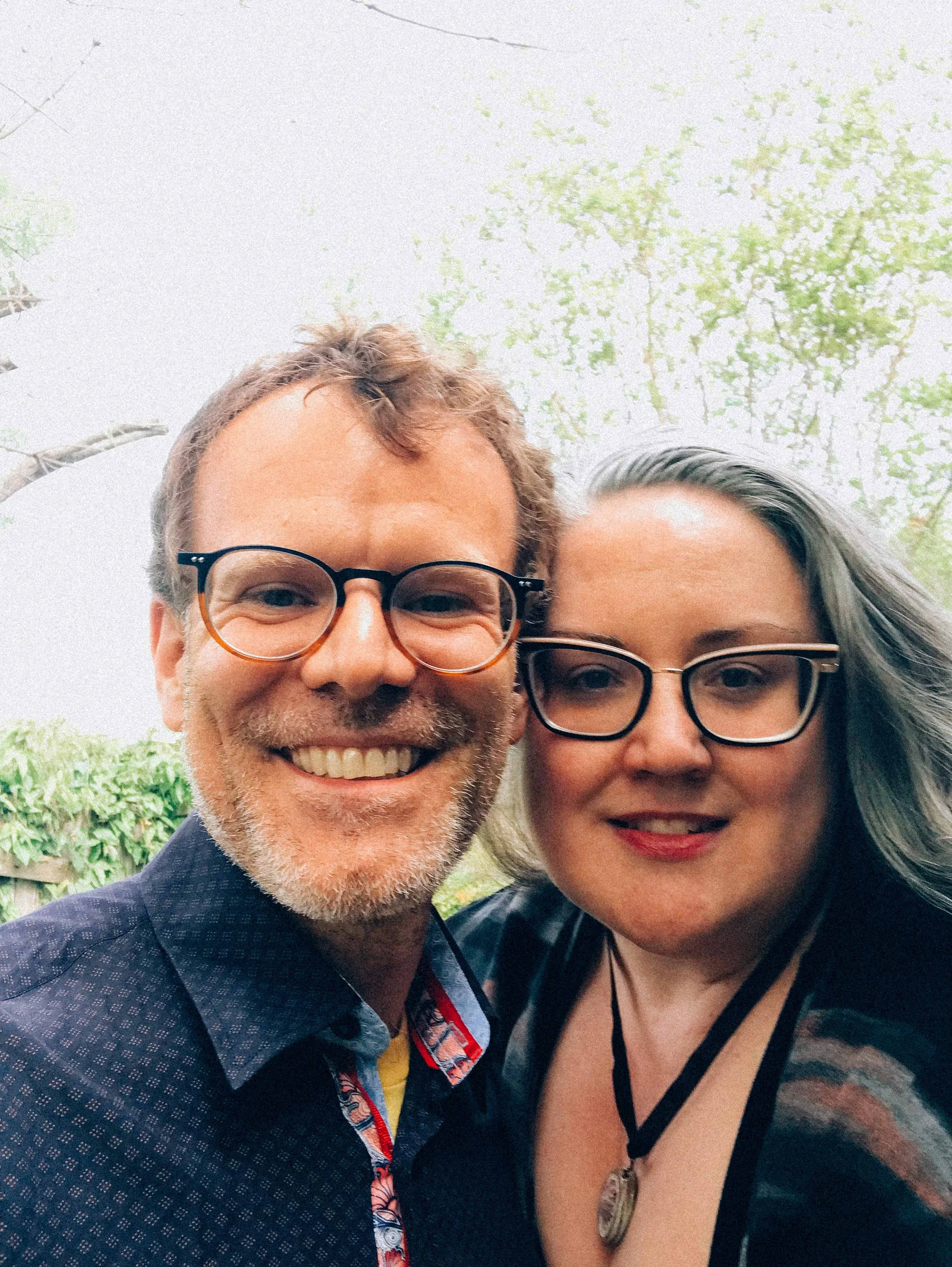 Dr. Tyson Lewis and artist and author Dr. Anne Keefe are pictured outside with trees in the background.