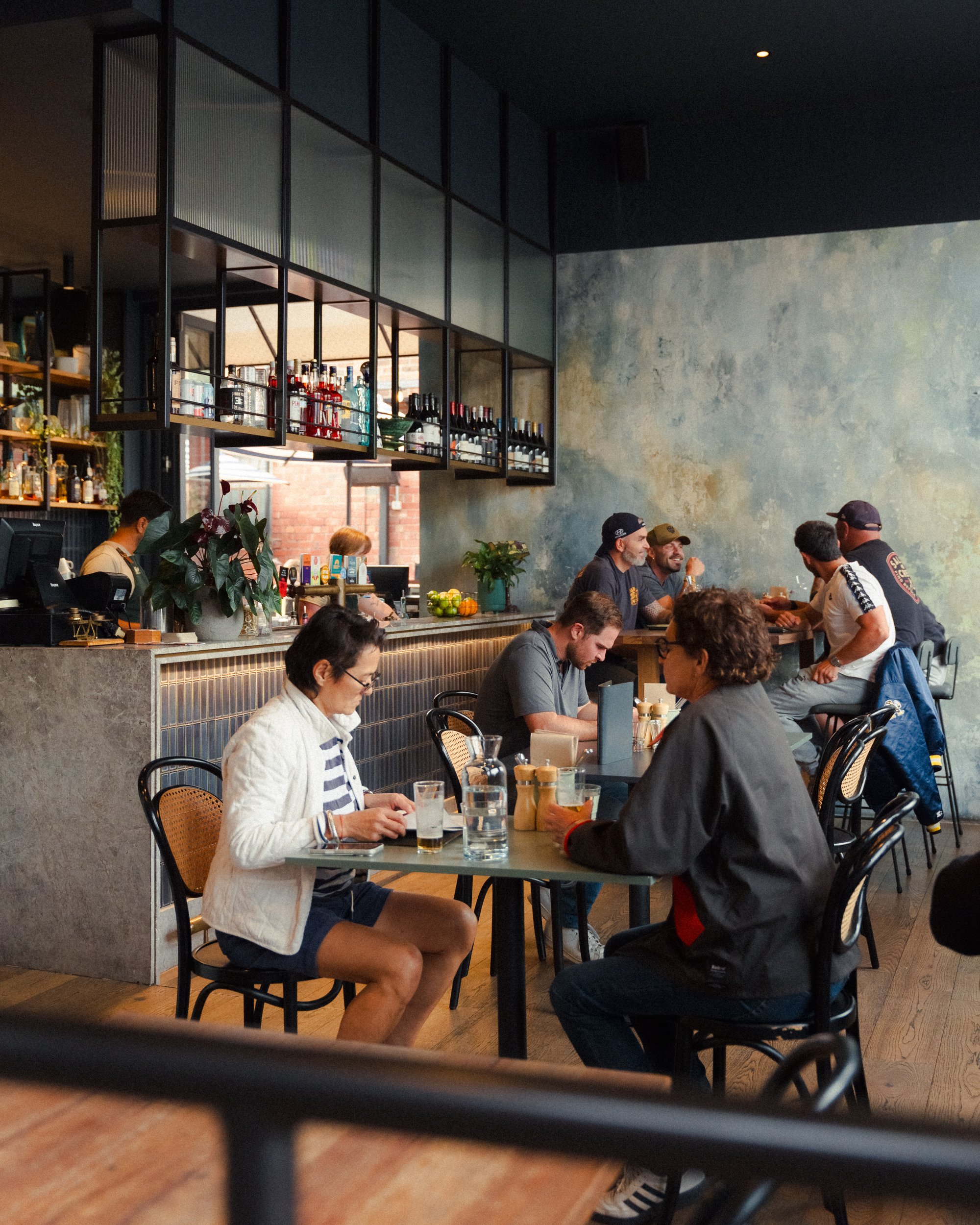 Guests dining at Teller front bar