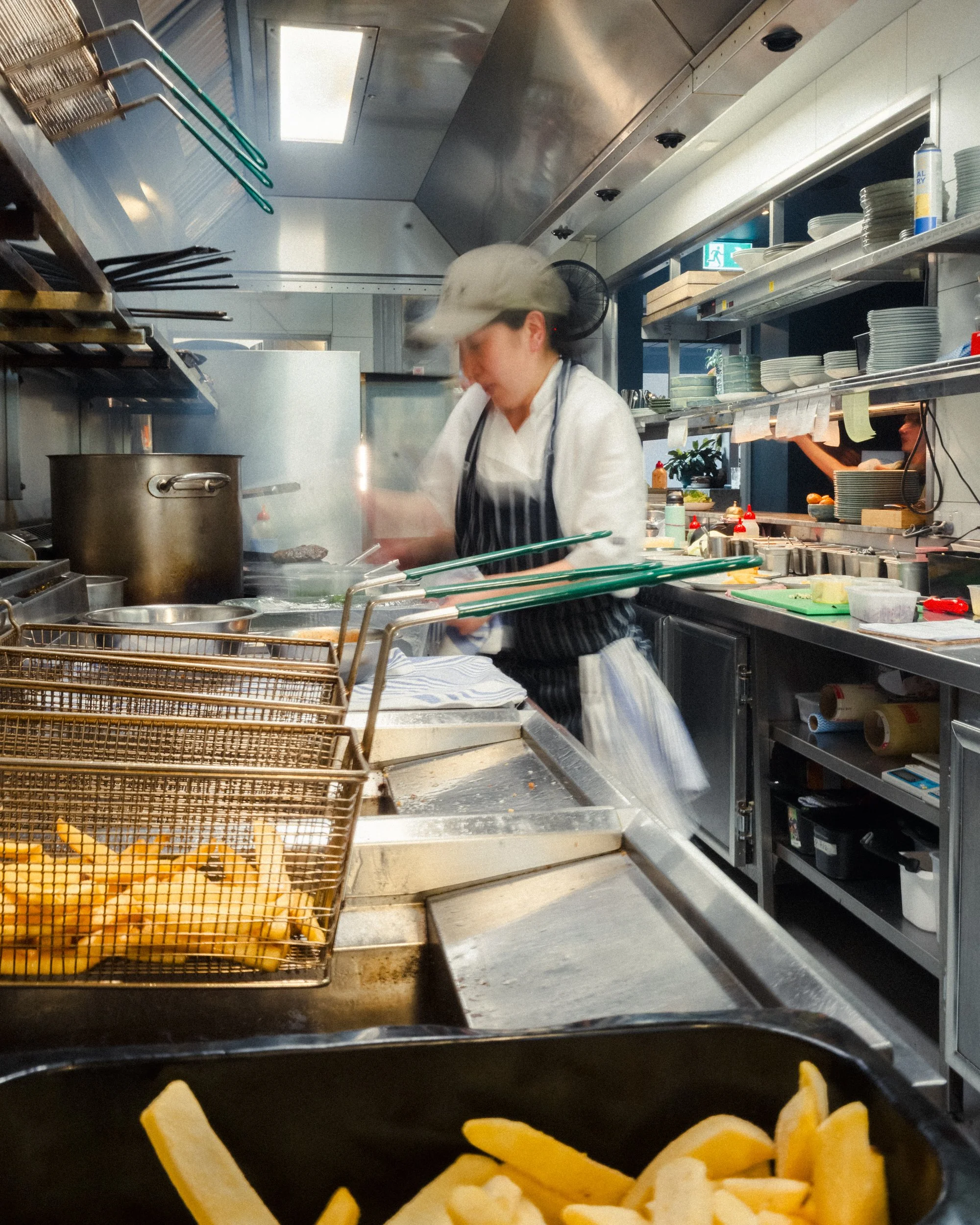 Kitchen staff preparing food at teller