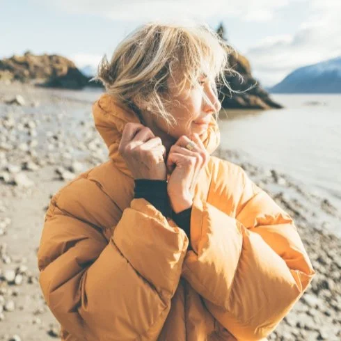 Rosey enjoying a quiet moment outdoors in a yellow jacket