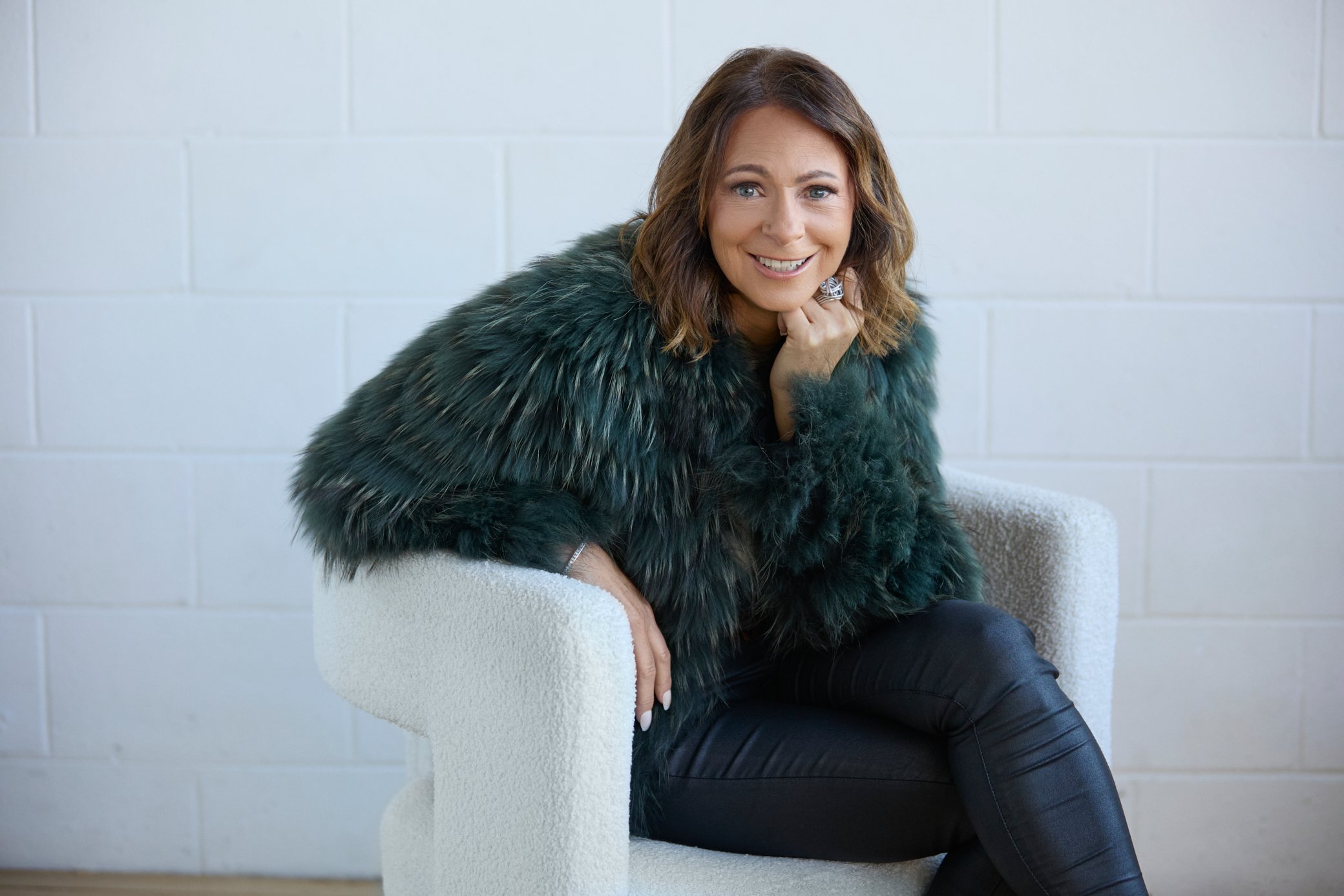 Branding portrait of woman sitting on chair.