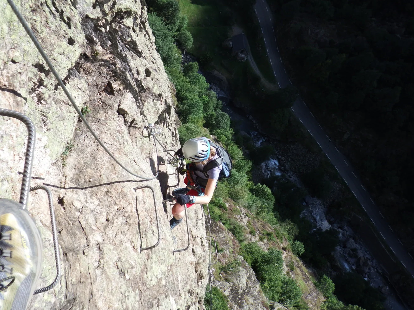 You can see the steel cable that you clip on to to the right of the steel staples on the rock (and above the road below).