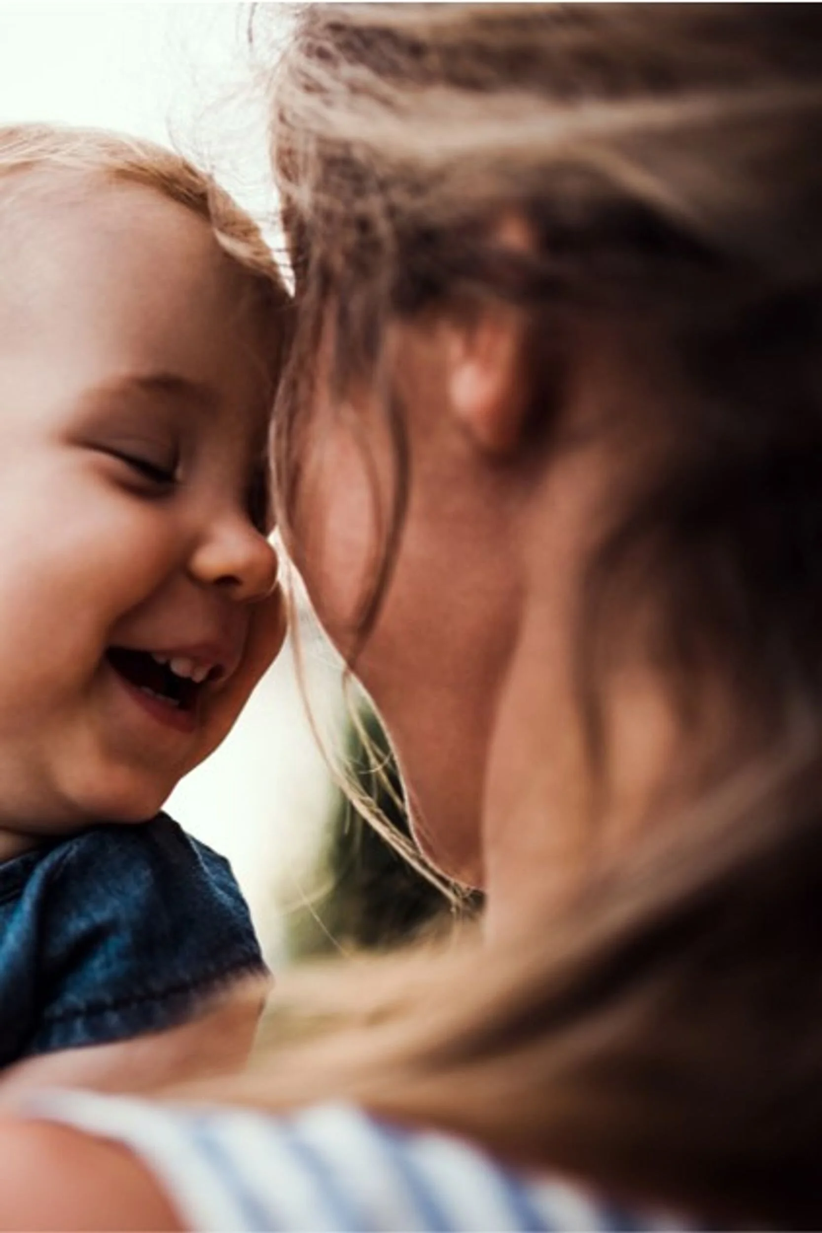 Mum and toddler touching faces