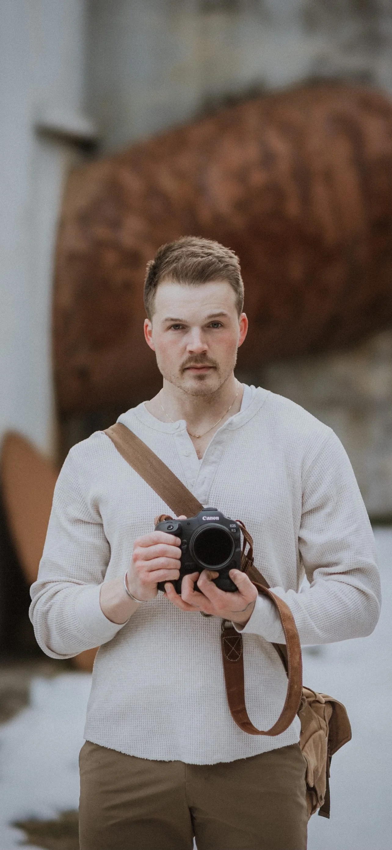 Brady Huxter, wedding filmmaker, holding his camera