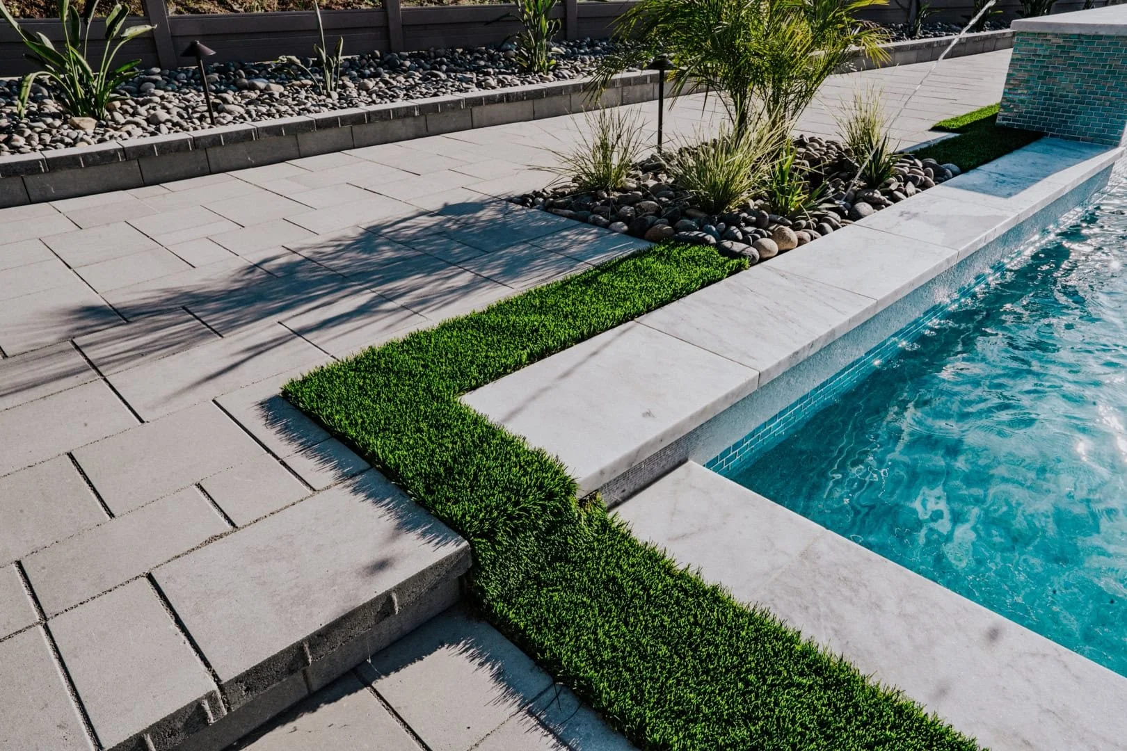 Detailed image of custom pool with hardscaping and artificial grass.jpg