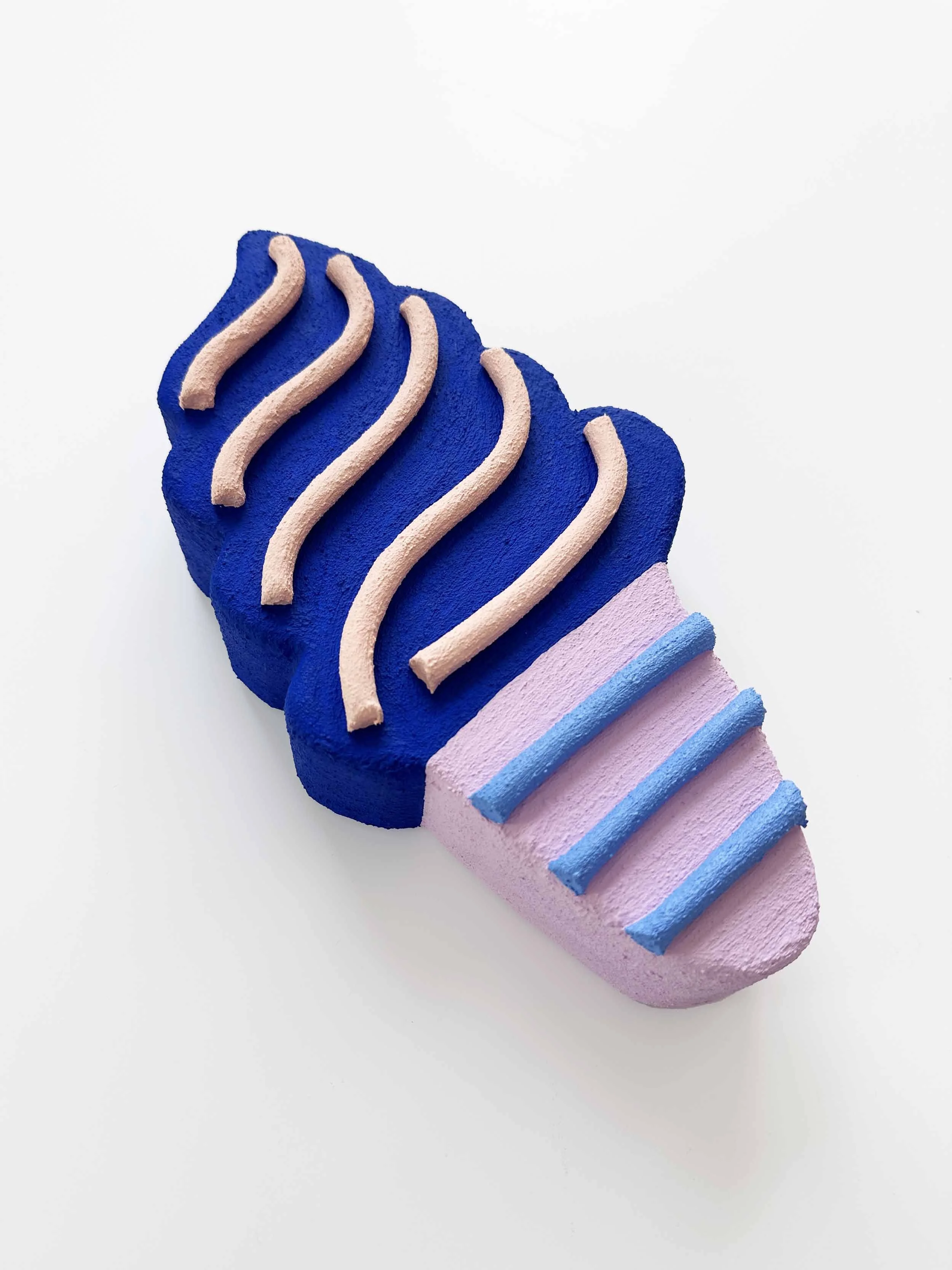 Side view of blue and lilac ice cream sculpture wall art by Steph Blondet, playful dessert-inspired artwork