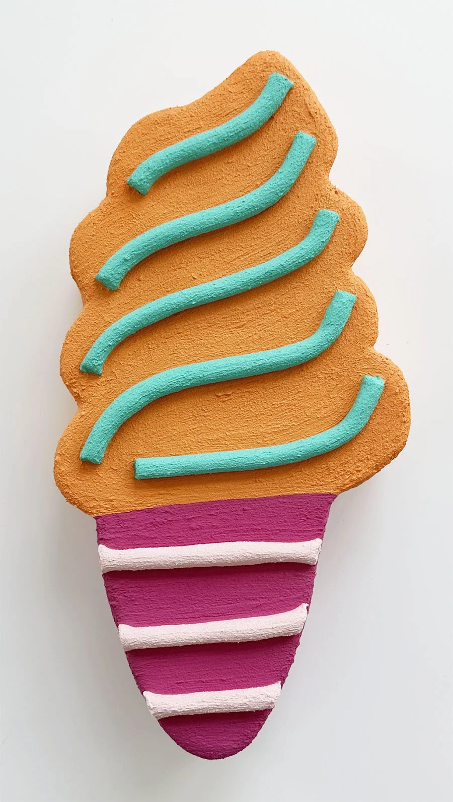 Close-up of light orange and magenta ice cream sculpture wall art by Steph Blondet, playful dessert-inspired artwork