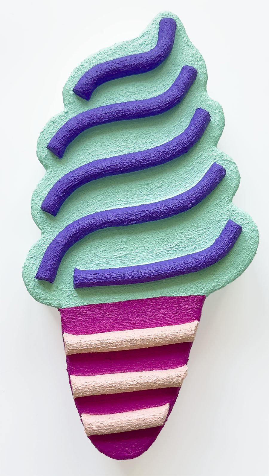 Close-up of light green and magenta ice cream sculpture wall art by Steph Blondet, playful dessert-inspired artwork