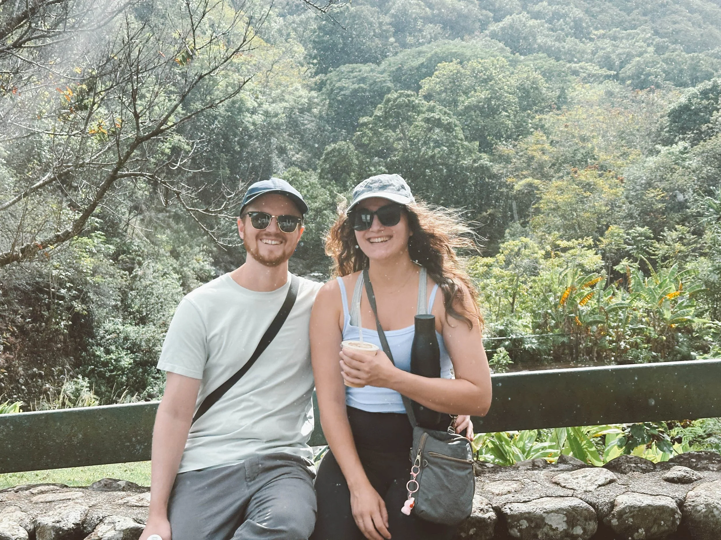 Amy Suto and her partner at ʻĪao Valley State Monument, Maui Hawaii, surrounded by lush rainforest and mountain views. A highlight from Amy Suto’s Maui travel guide exploring nature trails and scenic drives across the island.