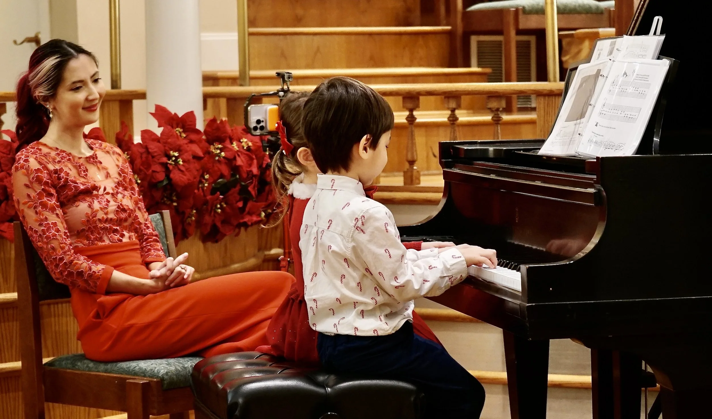 Sara Zeng looks at her students proudly as they perform a festive piano duet.