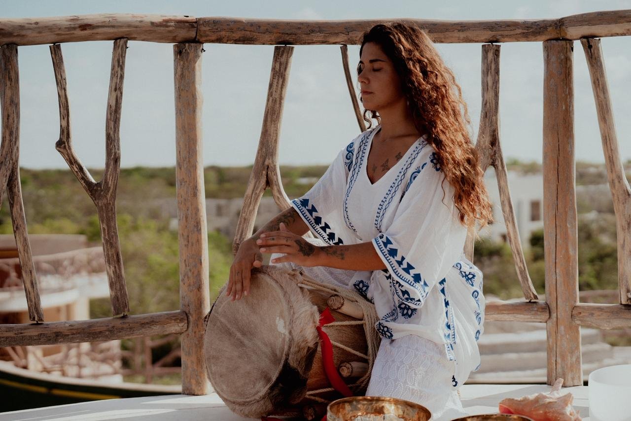 Frida Lopez, playing drum, in a ceremonial space in Tulum. 