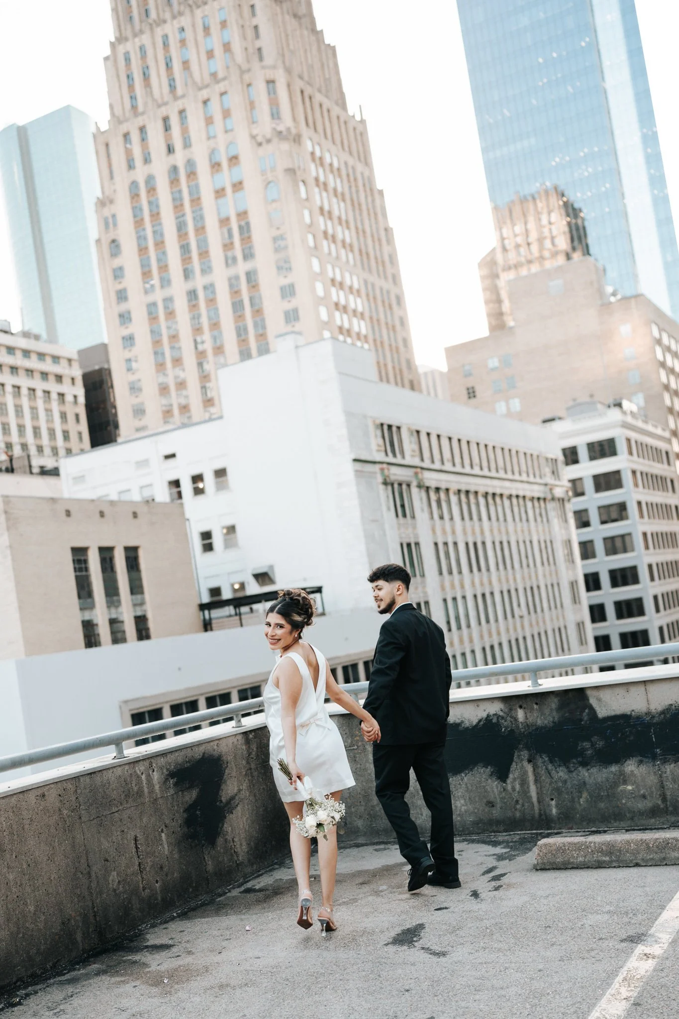 Intimate Houston elopement portraits of newlyweds on a rooftop after 1910 courthouse wedding
