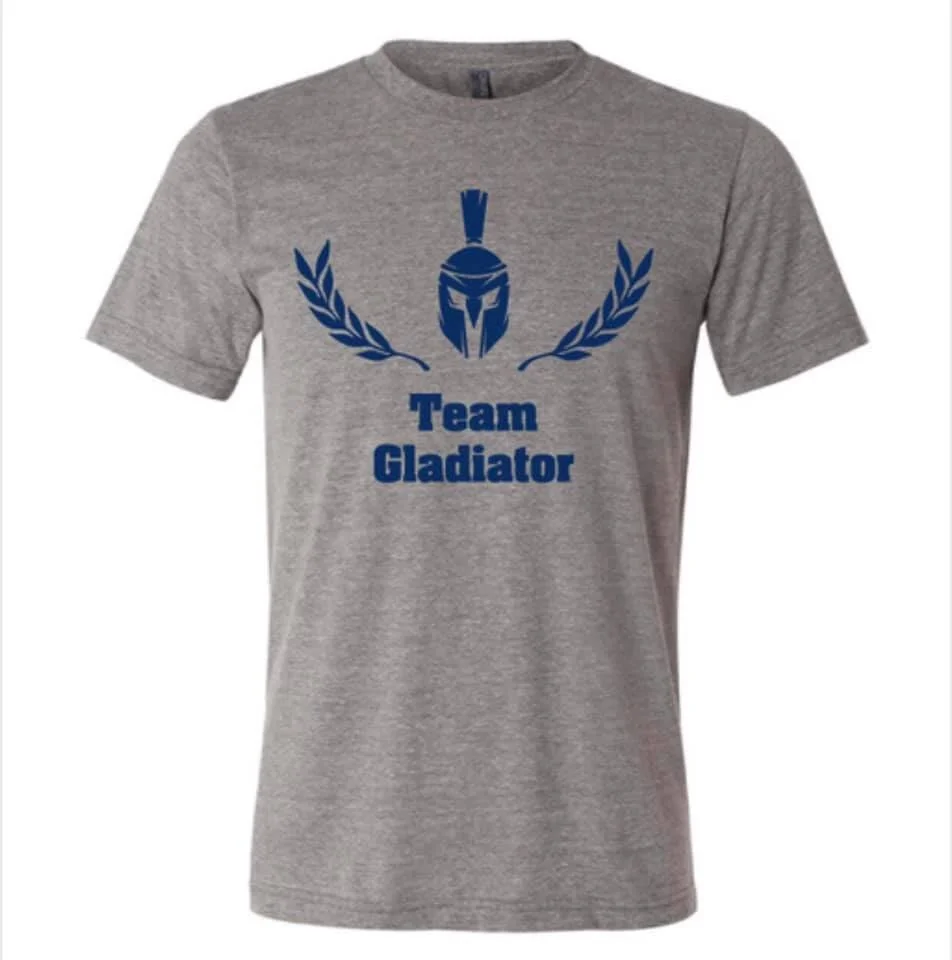 Gray t-shirt with blue Gladiator Project logo above blue text "Team Gladiator"