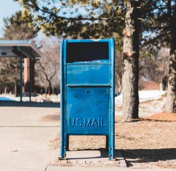 Blue mailbox on sidewalk