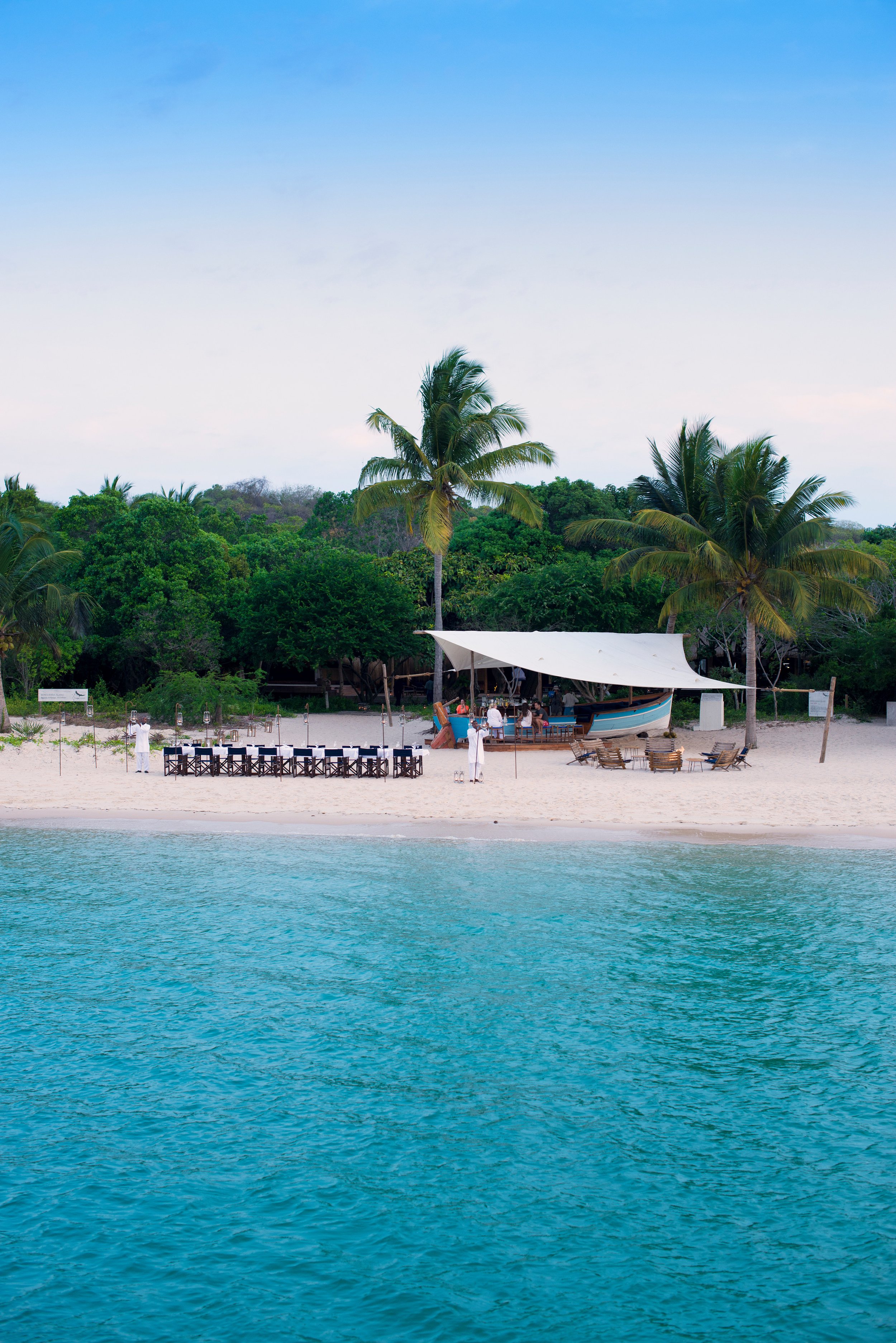 14-Benguerra-island-guest-area-Dhow-bar-portrait-staff-setting-up.jpg