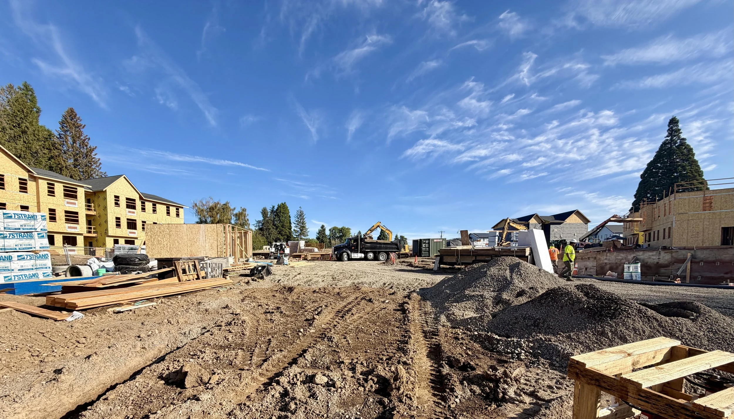Multifamily construction site in Salem, Oregon — several buildings underway simultaneously, framing and site work in progress