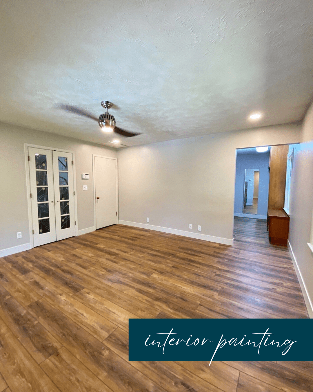 Empty living room with wood flooring, white walls, a ceiling fan, and French doors.