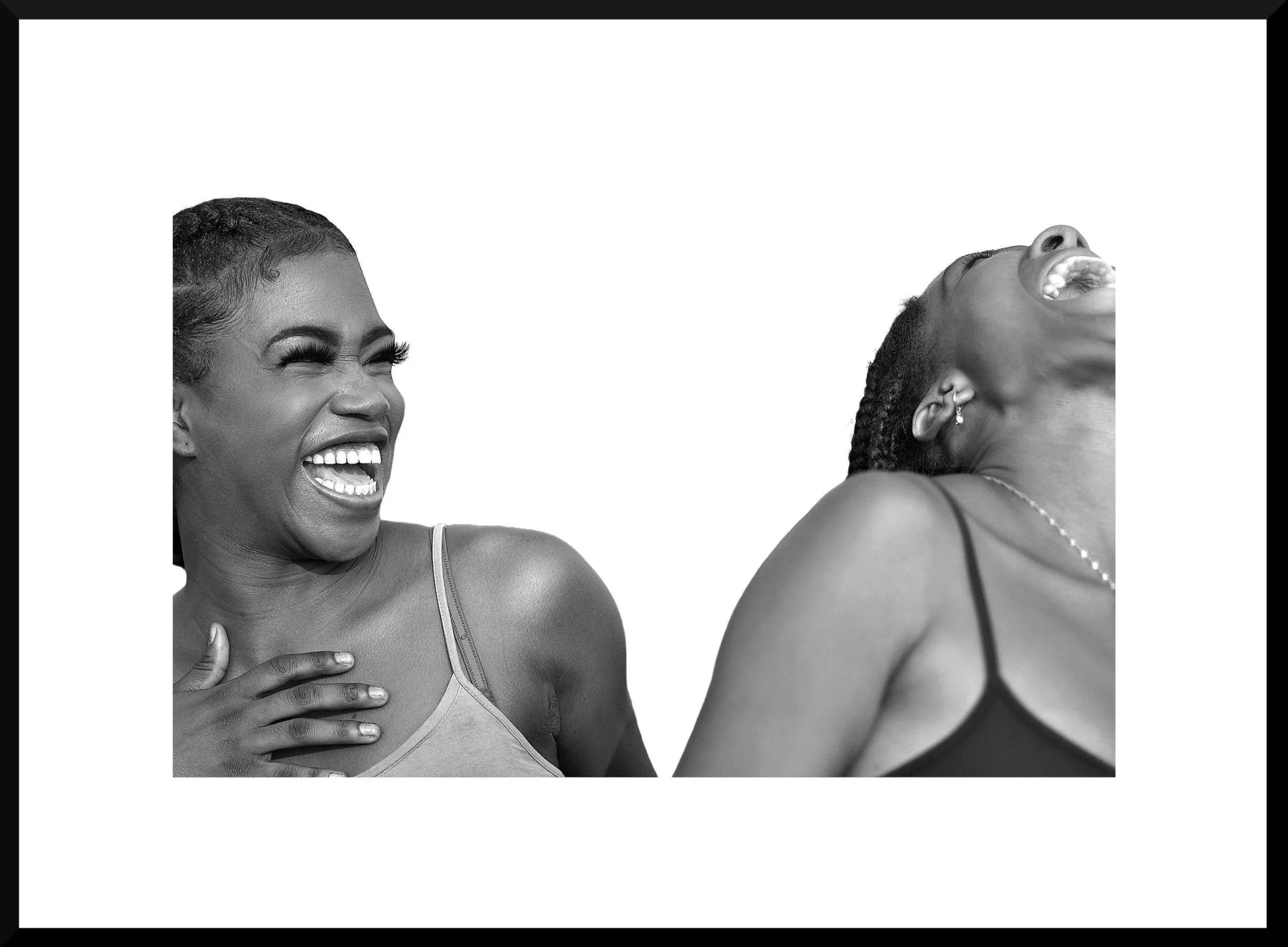 Two women laughing and smiling, one on the left with hand on chest, the other on the right in profile, both wearing tank tops, black and white photo.