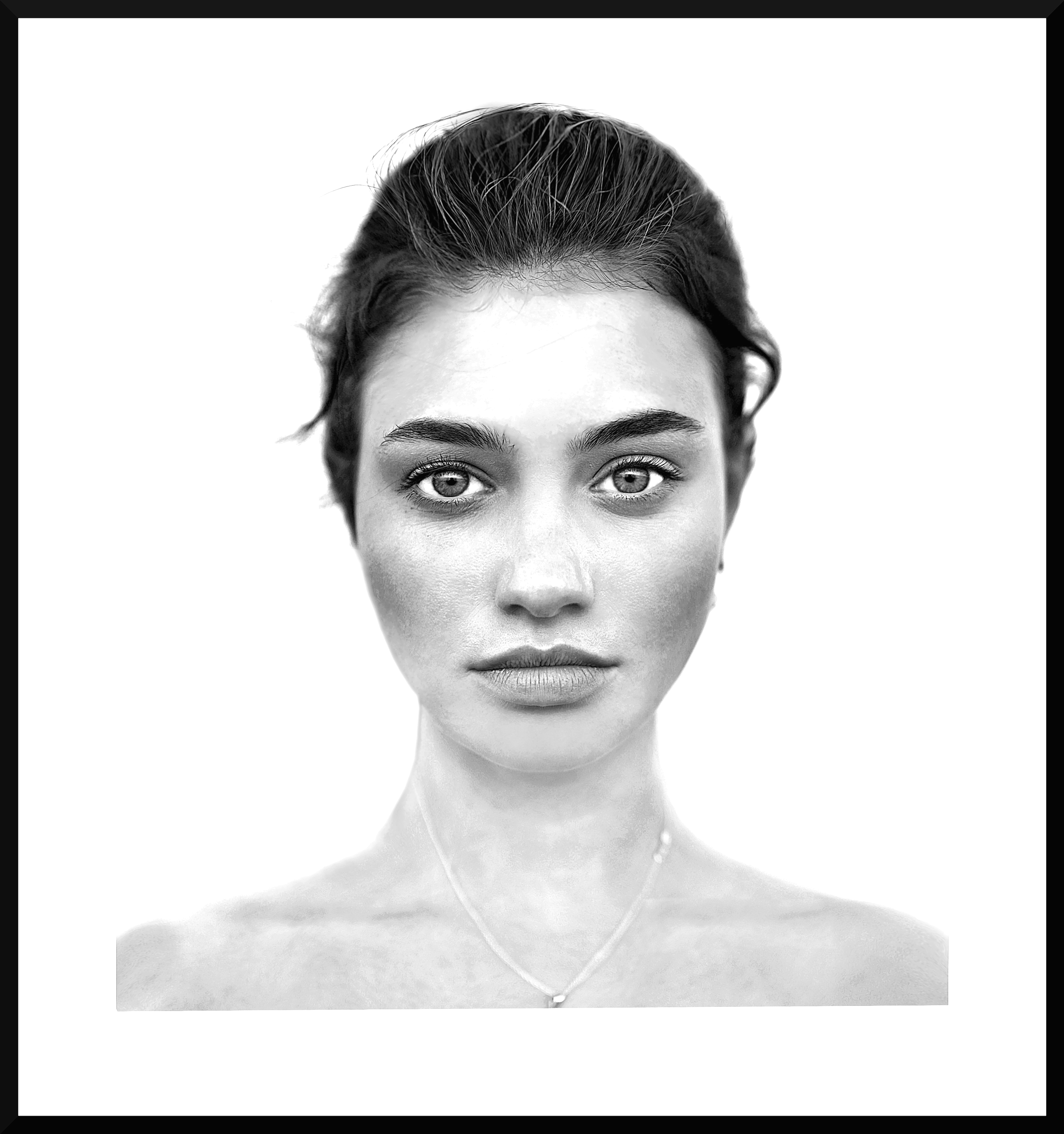 Close-up black-and-white photo of a woman with short hair and bright eyes, wearing a necklace with a pendant and a V-neck top.