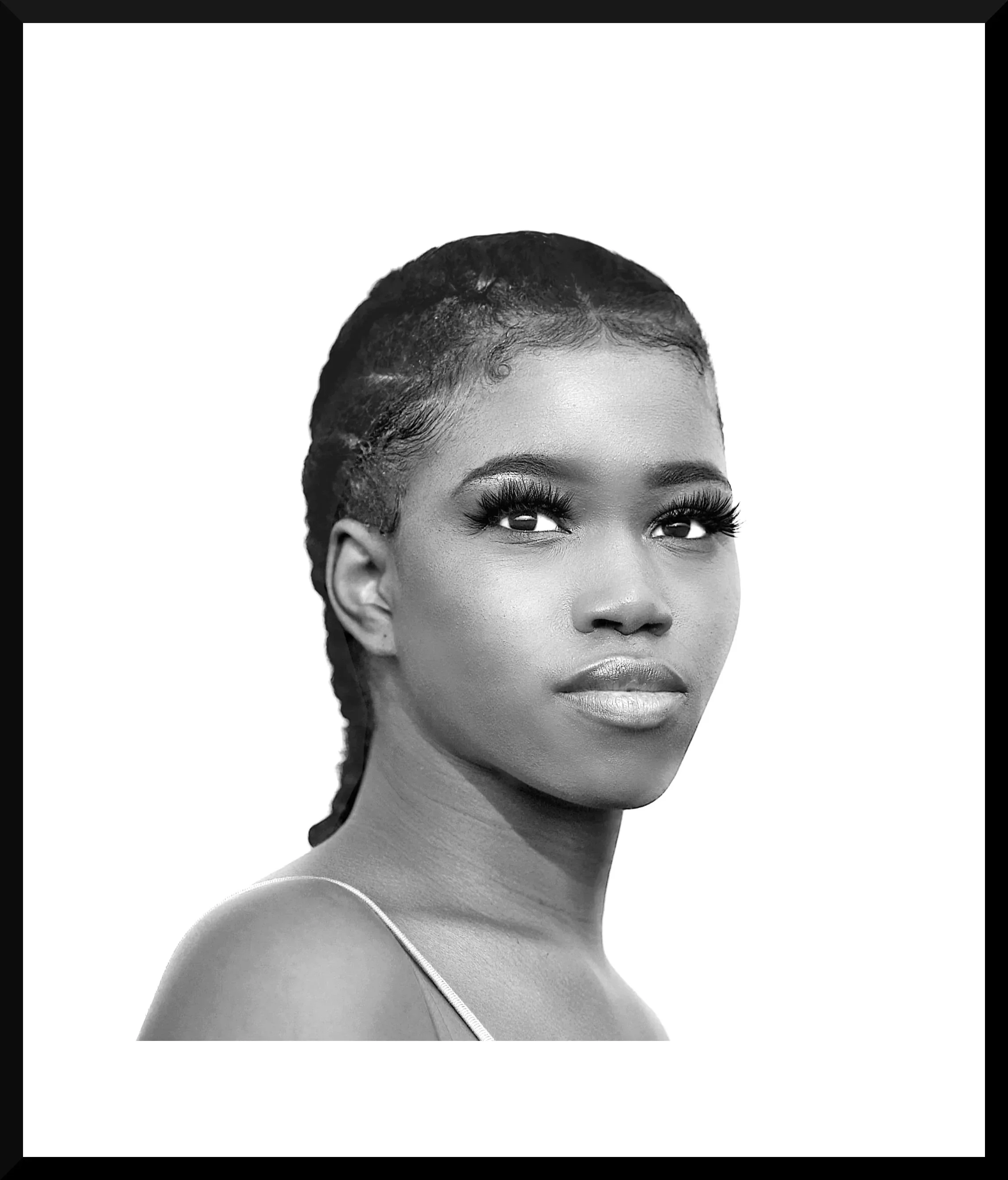 Black and white portrait of an African American woman with styled hair, full lips, and wearing a thin strap top.