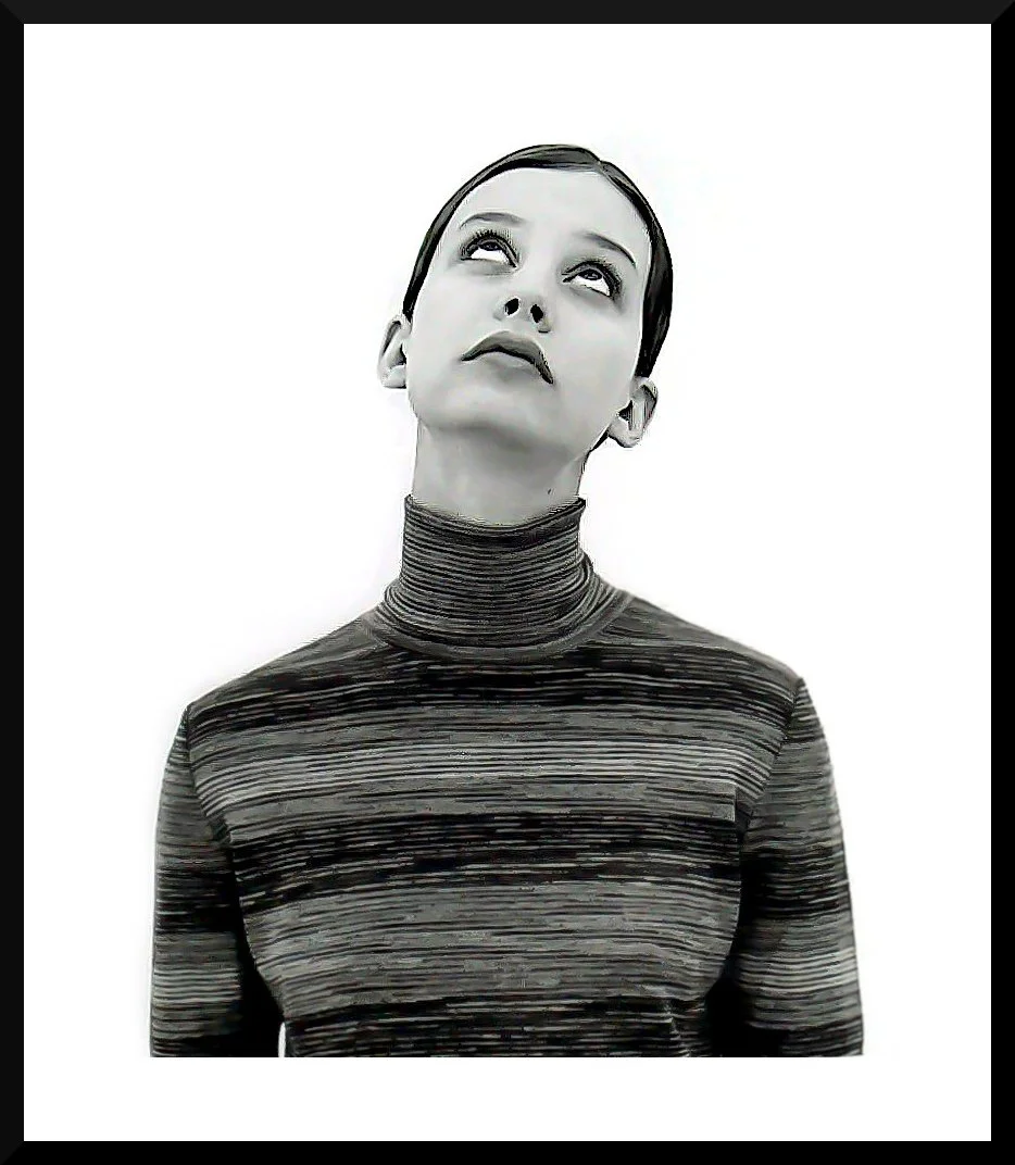 A black-and-white portrait of a woman with a striped turtleneck, looking upward with a neutral expression.