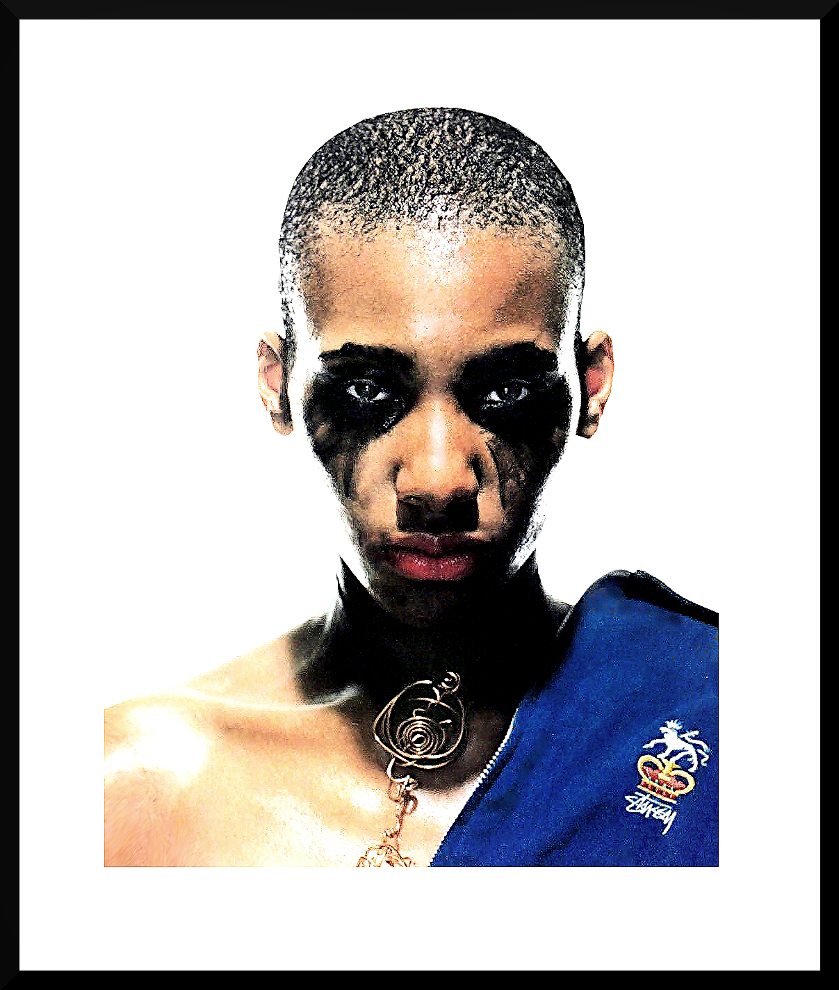 A person with a shaved head and black makeup around their eyes and nose, wearing a large metallic spiral necklace and a blue piece of clothing with a crown logo, against a white background.