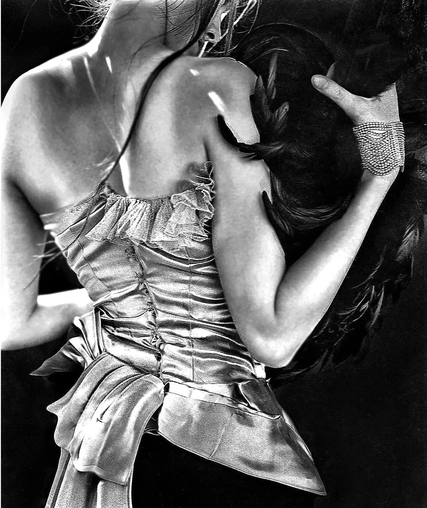 A person lying down wearing a shiny, ruffled, satin dress with a pearl bracelet, with long dark hair covering their face and arm across their forehead.