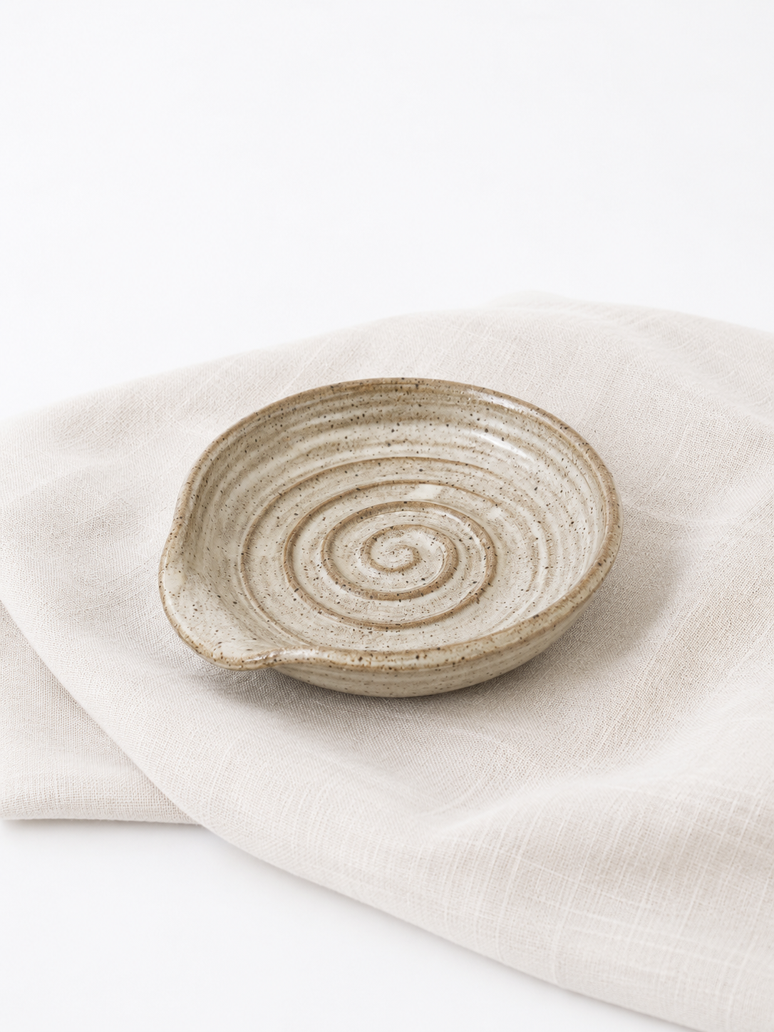 Handmade speckled stoneware spoon rest with spiral design by Hayes Ceramics