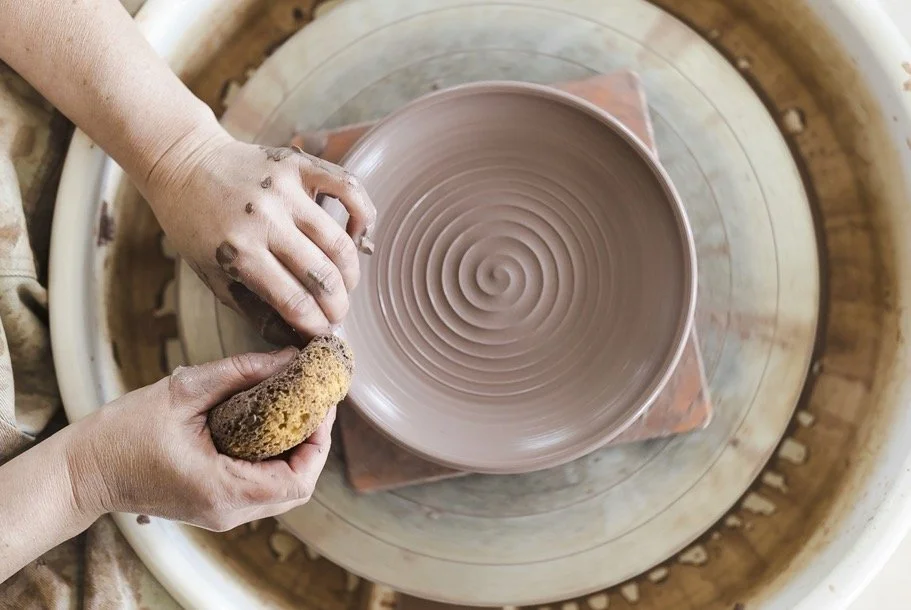 Ceramic artist Stephanie Hayes shaping a handmade stoneware bowl on the pottery wheel in her California studio.