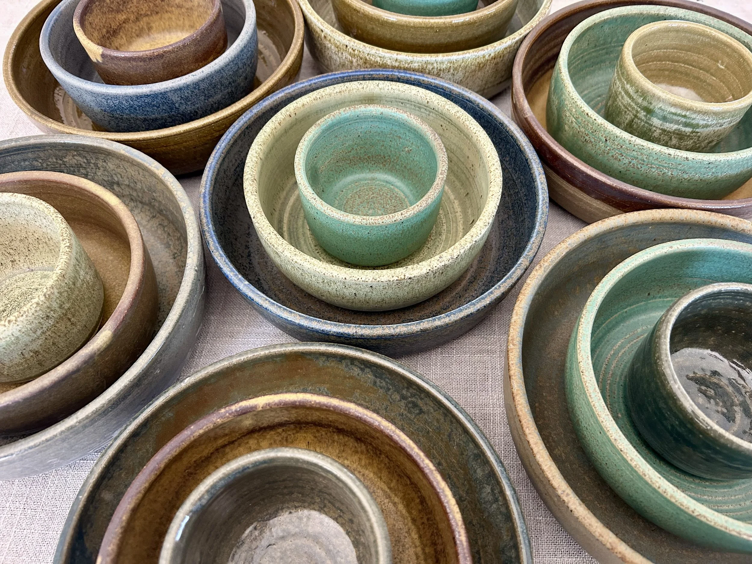 River Stone Collection featuring handmade stoneware bowls in five weathered matte glazes by Hayes Ceramics