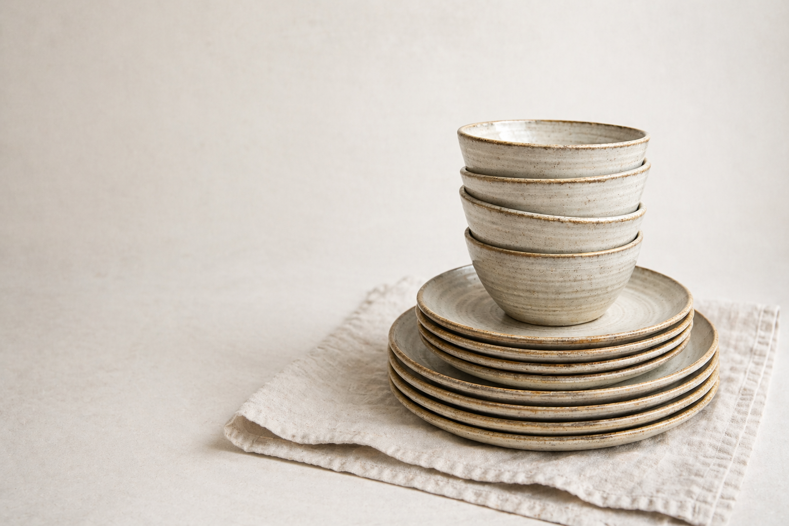 Handmade stoneware dinnerware set with stacked bowls and plates by Hayes Ceramics. Start a registry with the made-to-order catalog