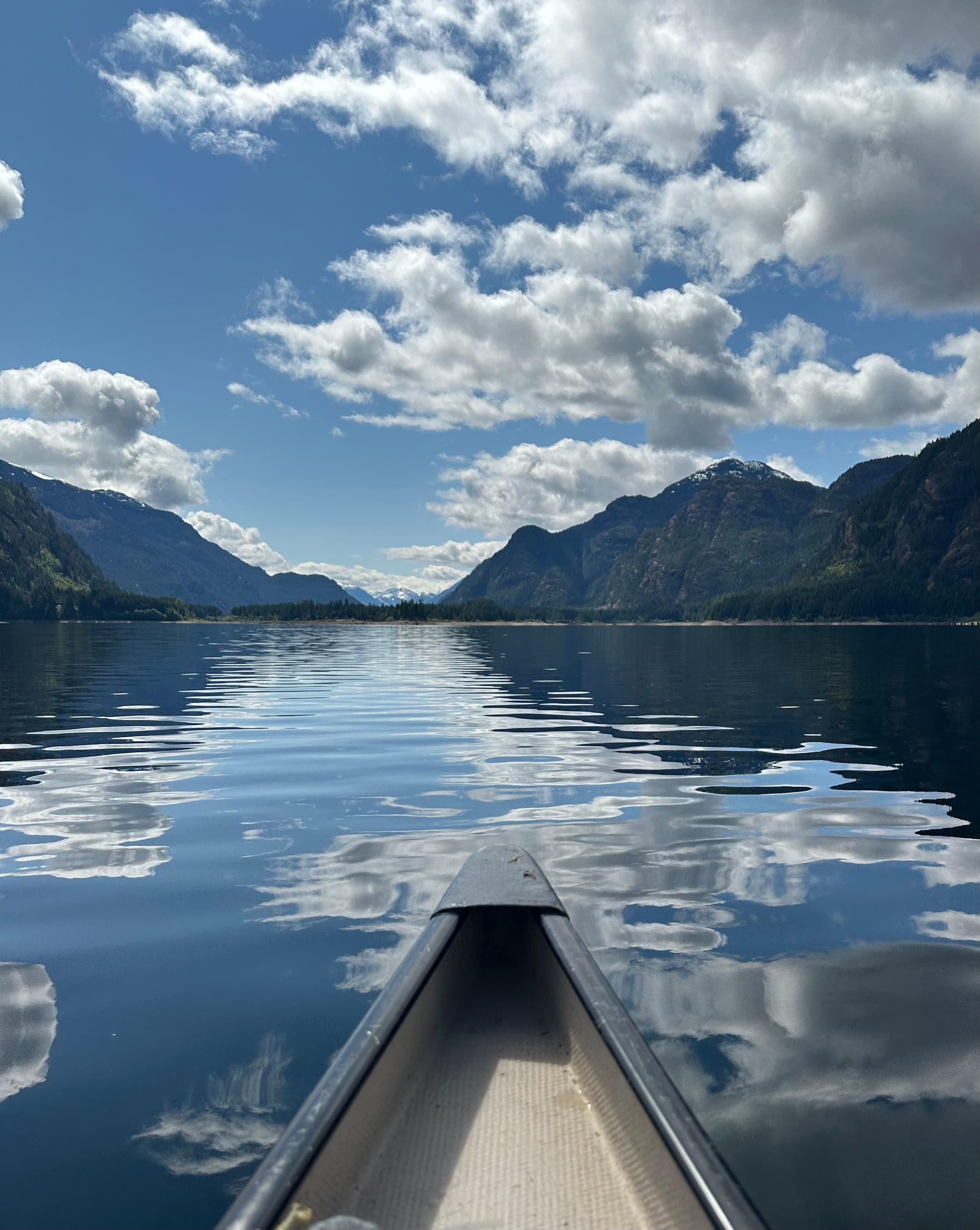 Bow of canoe on calm sunny lake