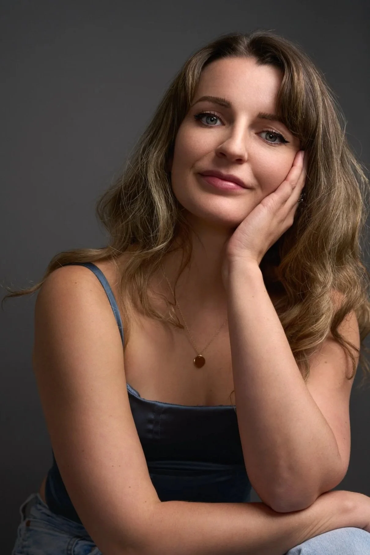 Madeleine smilling with long brown hair