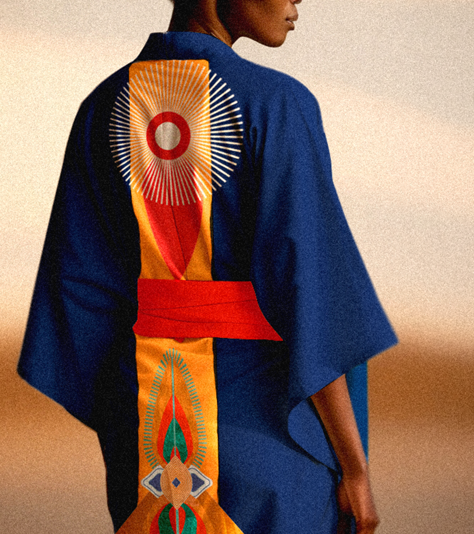 African woman wearing a deep blue kimono with design influenced by Japanese and bold African visual language.