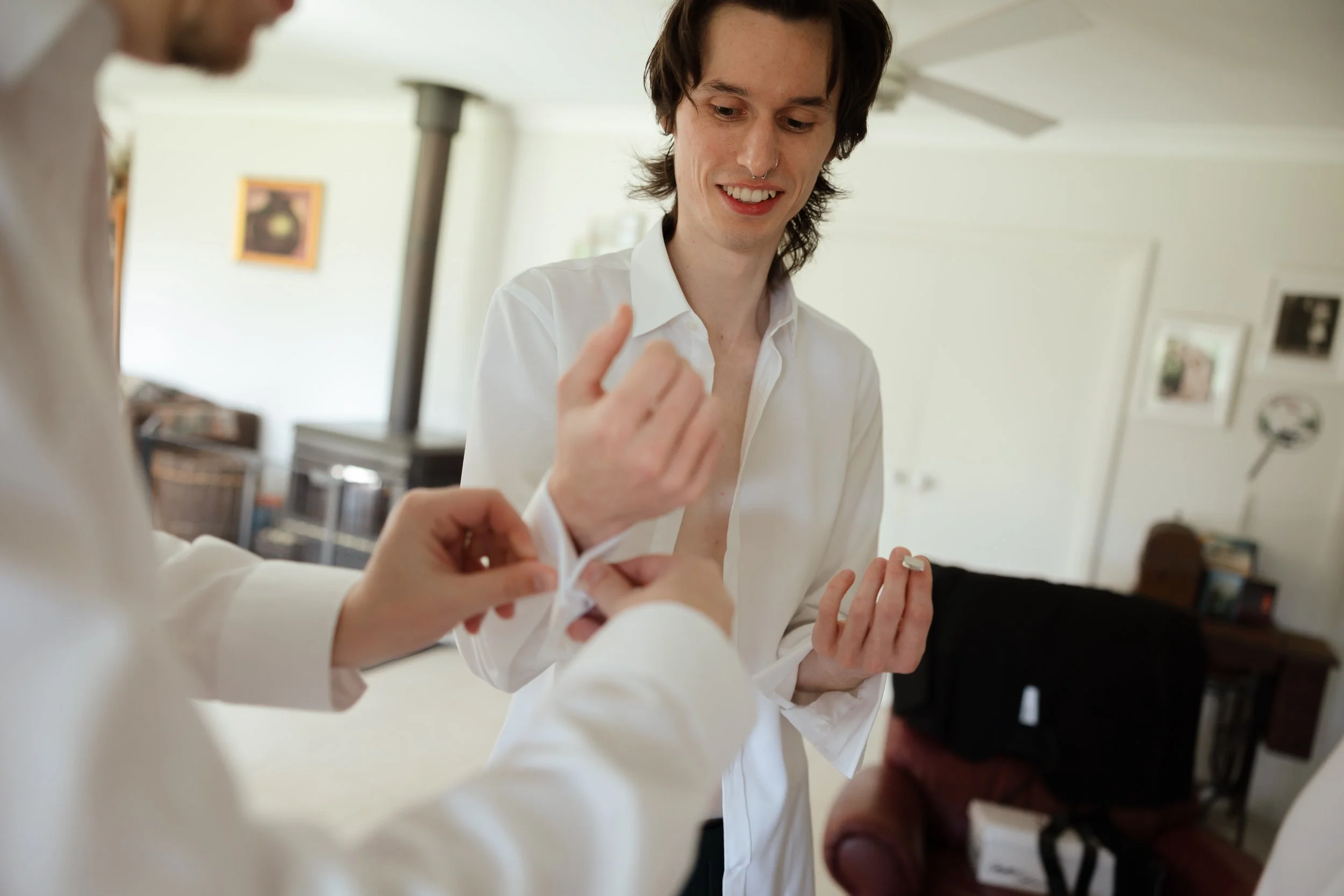man getting dressed for wedding