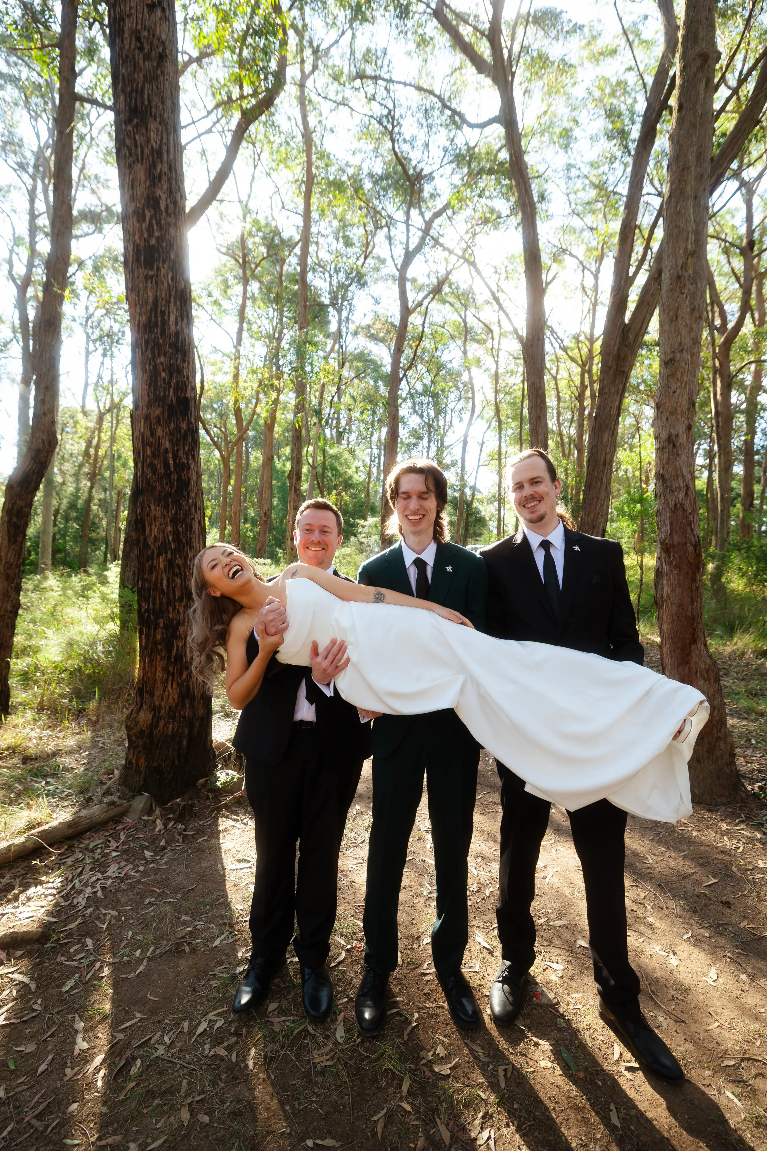 groomsmen lifting bride