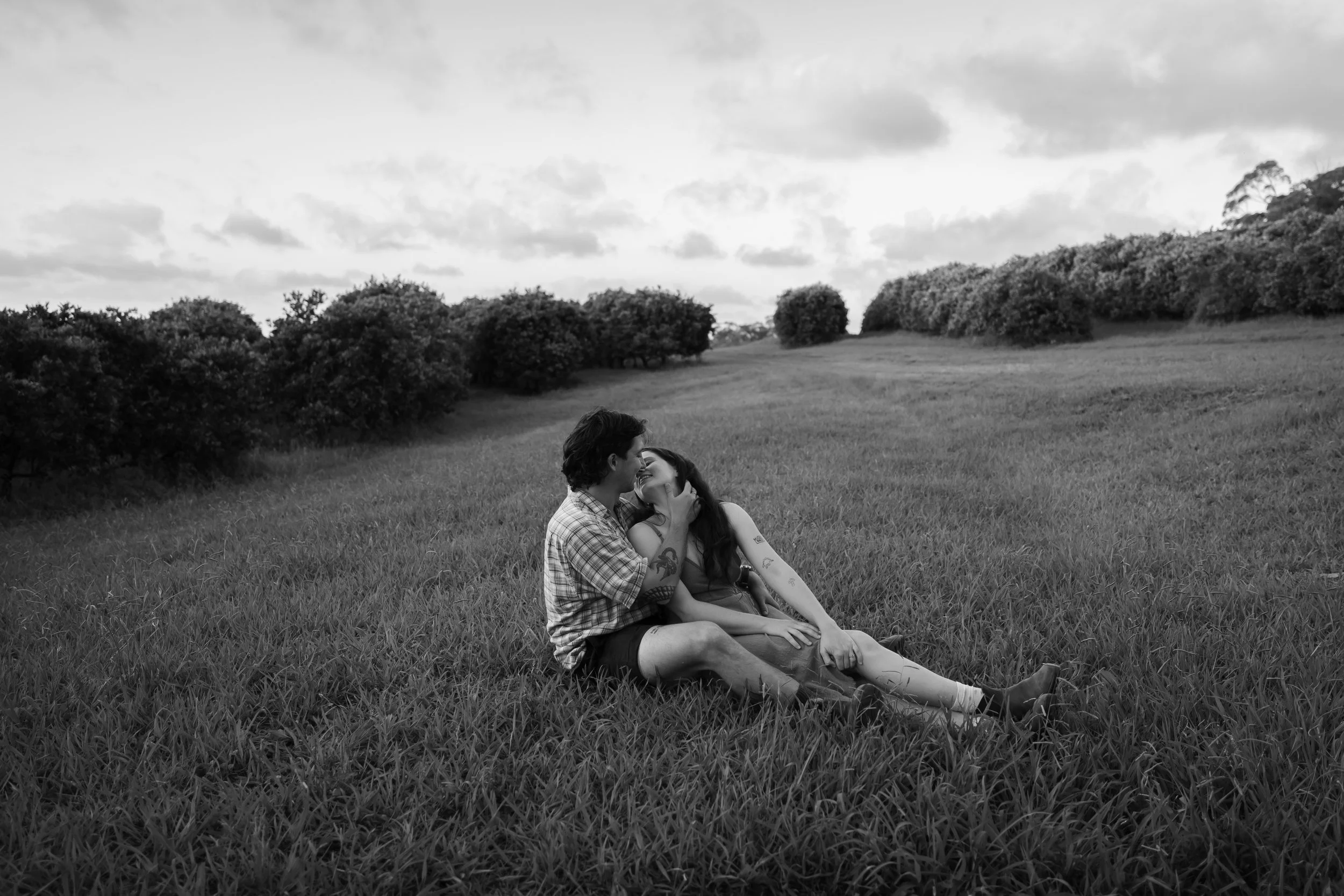 couple kissing in apple orchard