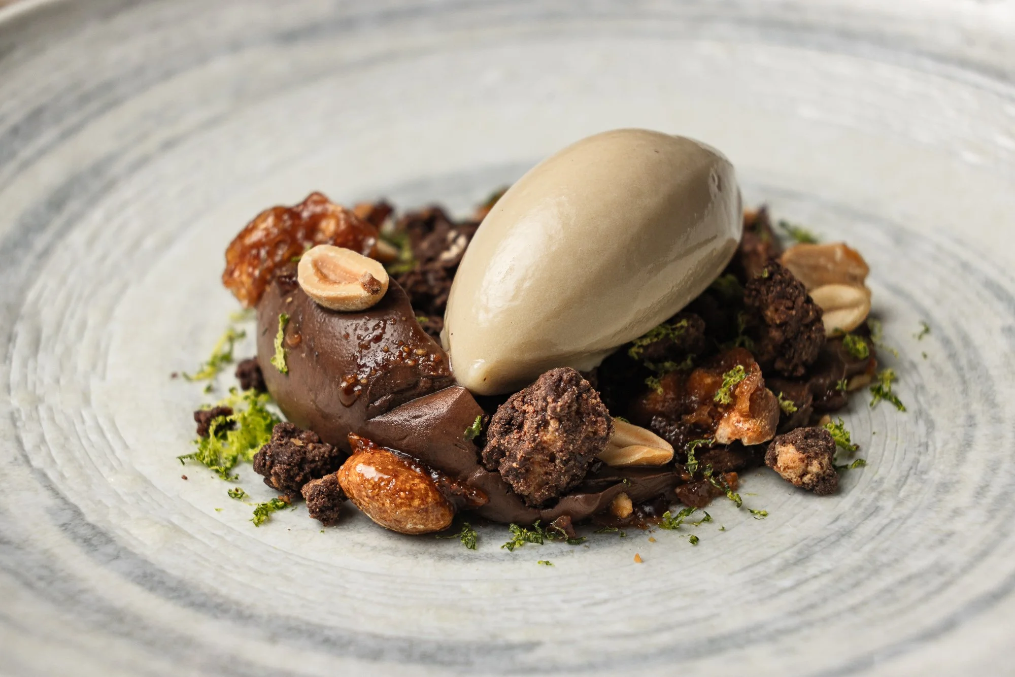 Commercial dessert photography, chocolate elements with ice-cream quenelle and peanuts for social and editorial, shot in Salisbury, Wiltshire, venue marketing in Falmouth, Cornwall, for use in London and Birmingham, West Midlands.