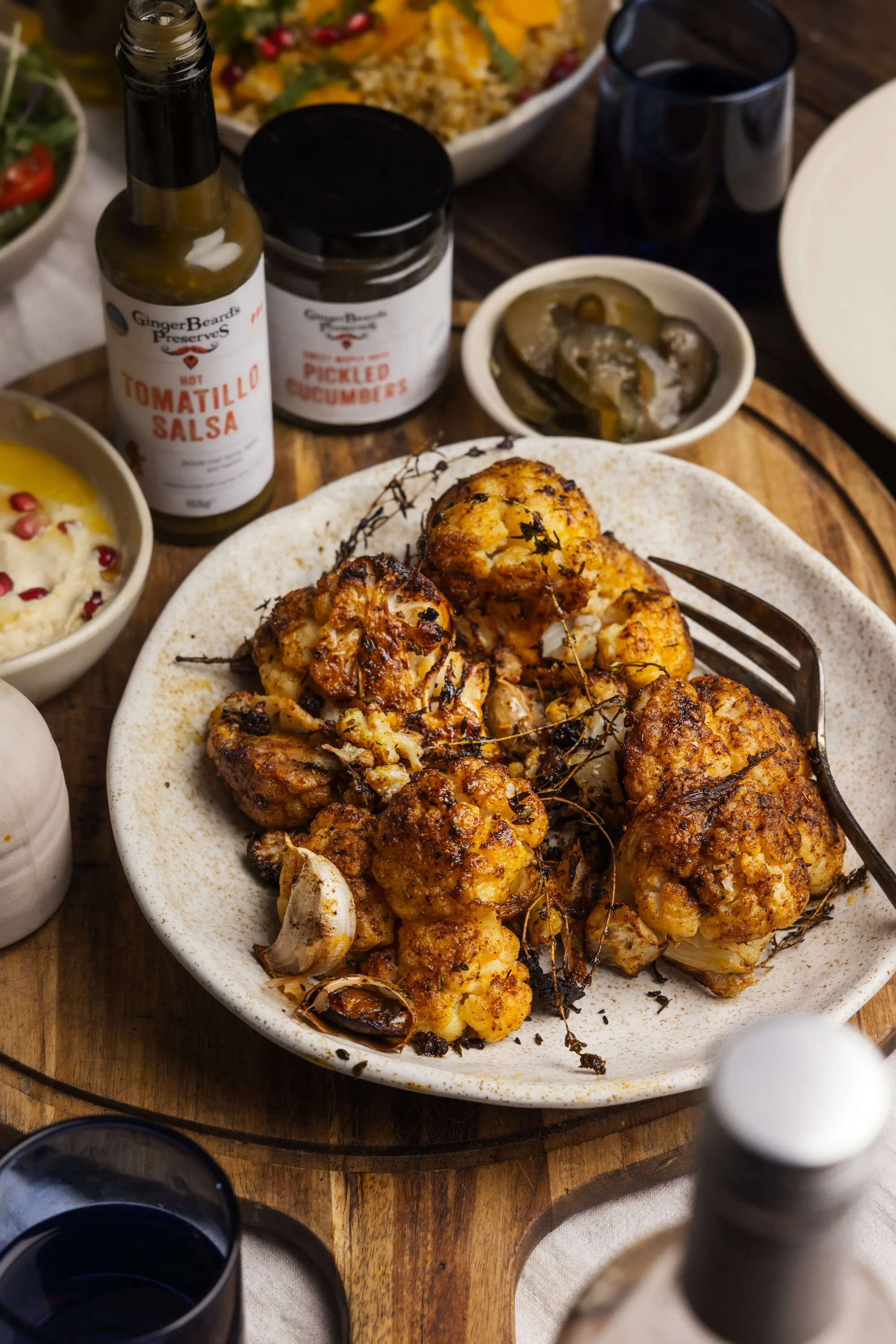 Commercial food product and recipe photograph of spiced roasted cauliflower served with sauces beside GingerBeard’s Preserves jars, created for the independent Bristol producer’s website and promotional content.
