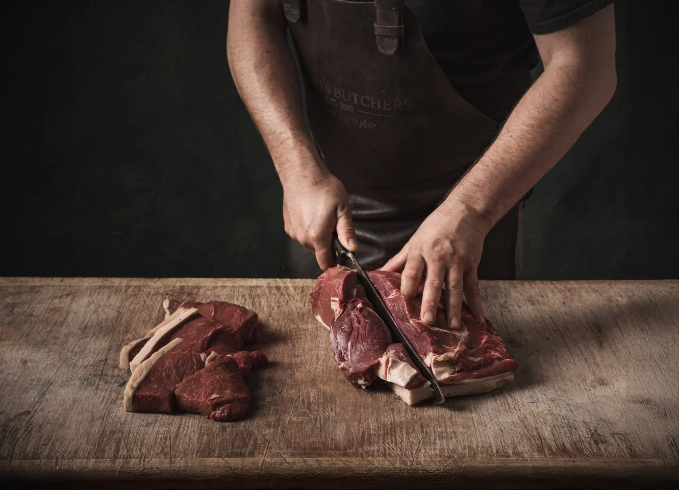 Commercial butchery photographer frame, butcher cutting beef on the block for online shop and POS, shot in Reading, Berkshire, origin in Truro, Cornwall, for use in London and Swindon, Wiltshire.