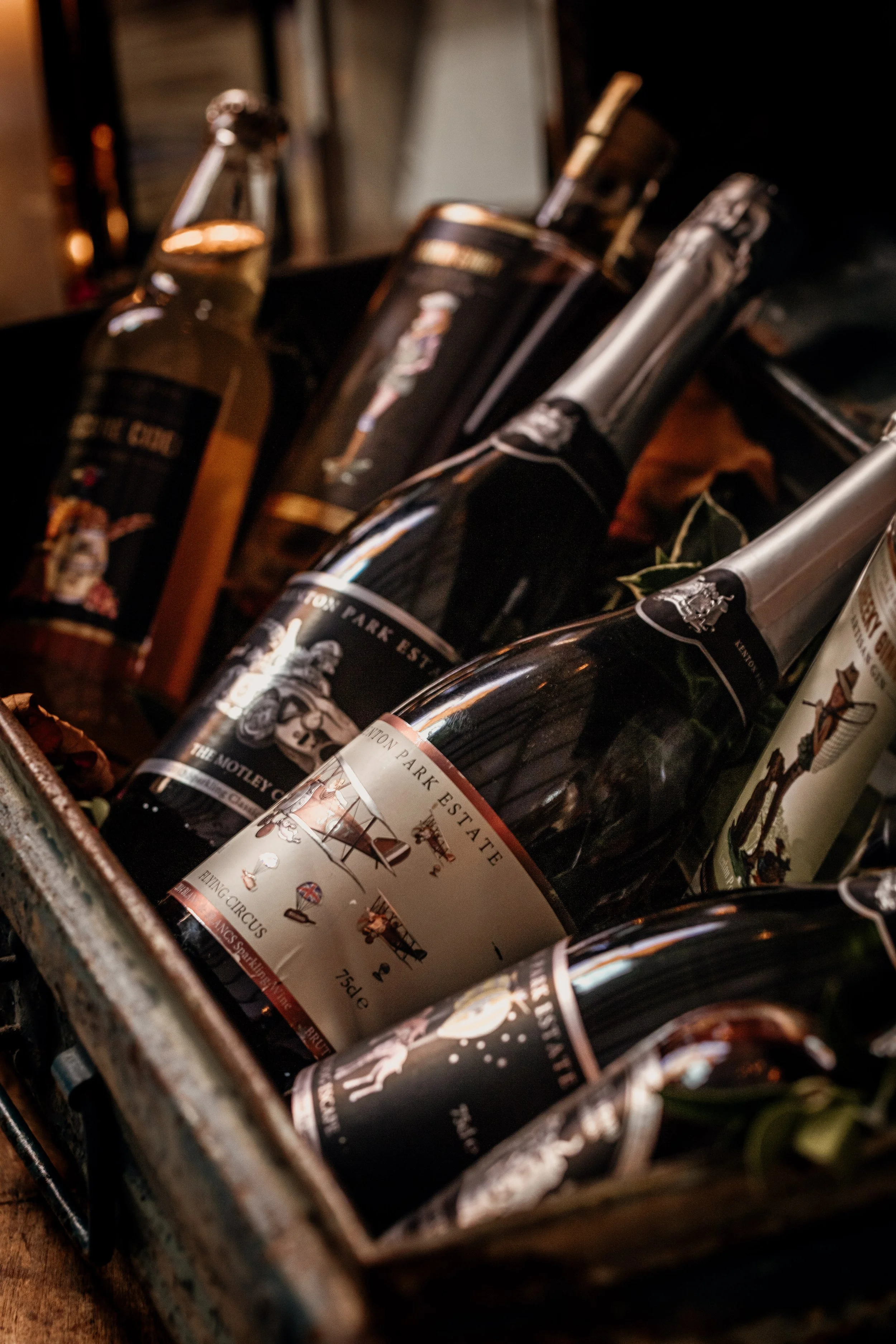 Selection of Kenton Park Estate & Vineyard wine bottles arranged in a wooden crate, photographed in Devon for product, brochure and website use.
