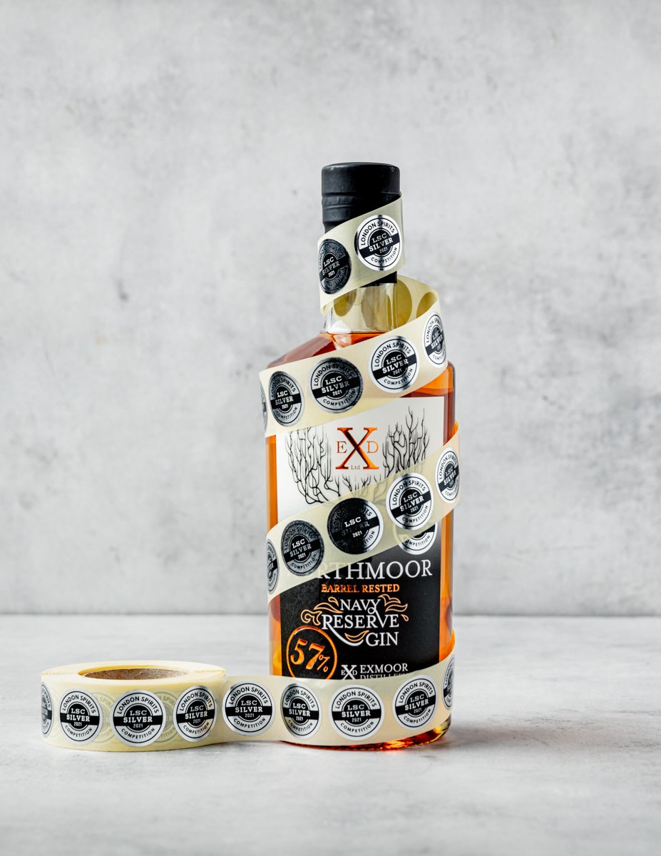 Elevate your senses with a glimpse of the Exmoor Distillery Gin, a visually striking bottle of premium spirit served in a trendy Cardiff and Bath city center bar.