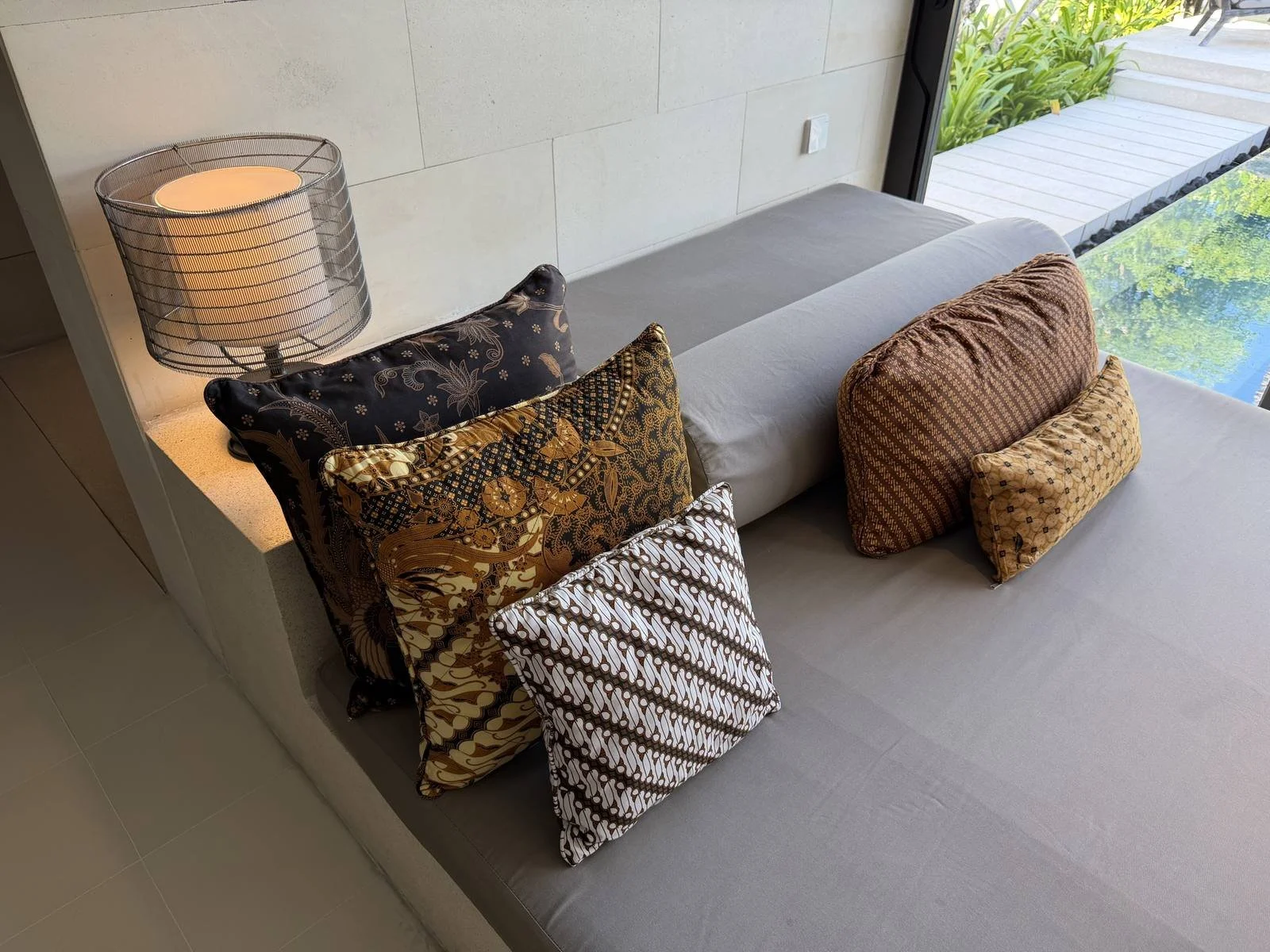 alila-villas-uluwatu-villa-living-room-batik-cushions-pool-view.jpg